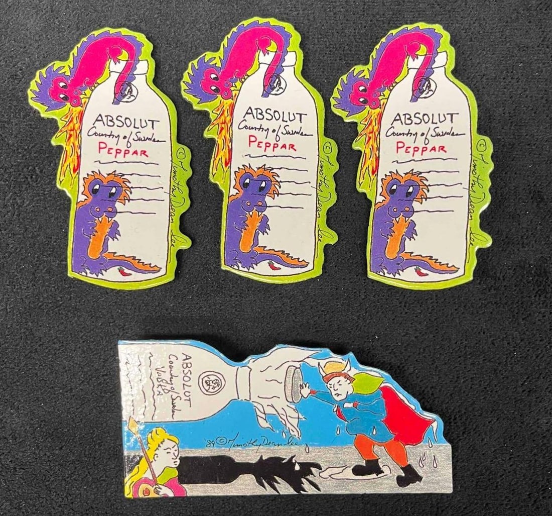 4 Absolut Vodka Peppar Advertising Art Pins / Brooches: This lot contains a 4 Absolut Vodka Peppar Advertising Art Pins / Brooches By Timothy Dean Lee. Each is made of a Laminated Art Board. This was released from the year 1990 to the year 1991. The three