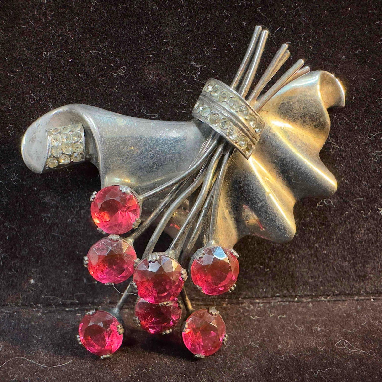Sterling Silver Floral Brooch with Large Pink and Small Clear Rhinestones: This piece of jewelry has been tested and researched prior to listing. Please view all our pictures as they are part of our description. DETAILS: Metal - Sterling Silver Color - Silver Stones - Yes Ha