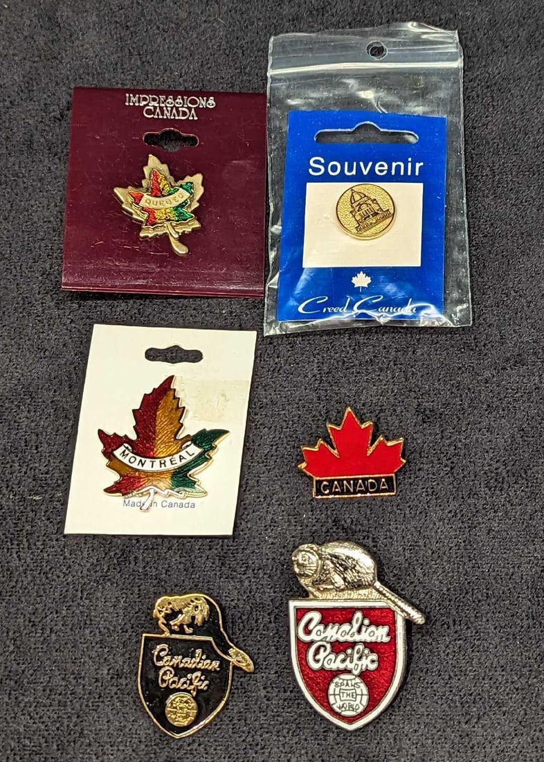 6 Assorted Souvenir Canadian Pins F18: 6 Assorted Souvenir Canadian Pins F18. This lot includes: (1) Impressions Canada Enameled Maple Leaf Brooch/Pin. This is approx 2" x 1/4" x 2 1/4". (1) Montreal Canada Enameled Maple Leaf