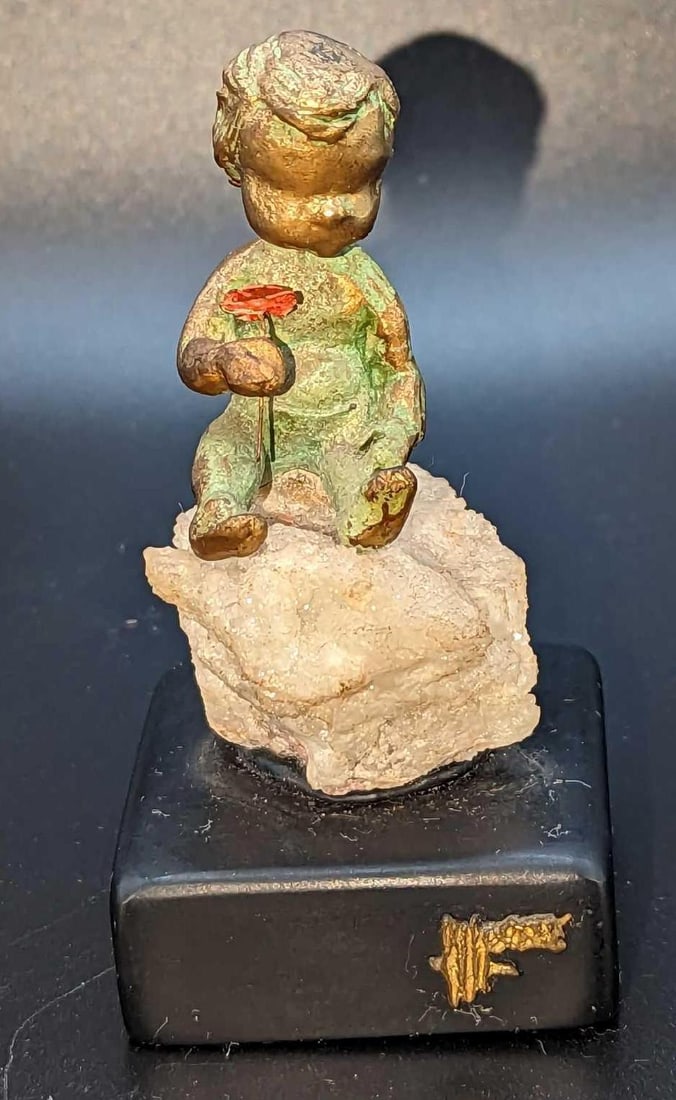 Vintage Malcolm Moran Child Bronze Sculpture: Vintage Malcolm Moran Child Bronze Sculpture. This was released in 1972. This is approx 2" x 2" x 3 3/4" and it weighs 0.33lb. The baby figurine sits on what appears to be a Geode rock. The base 