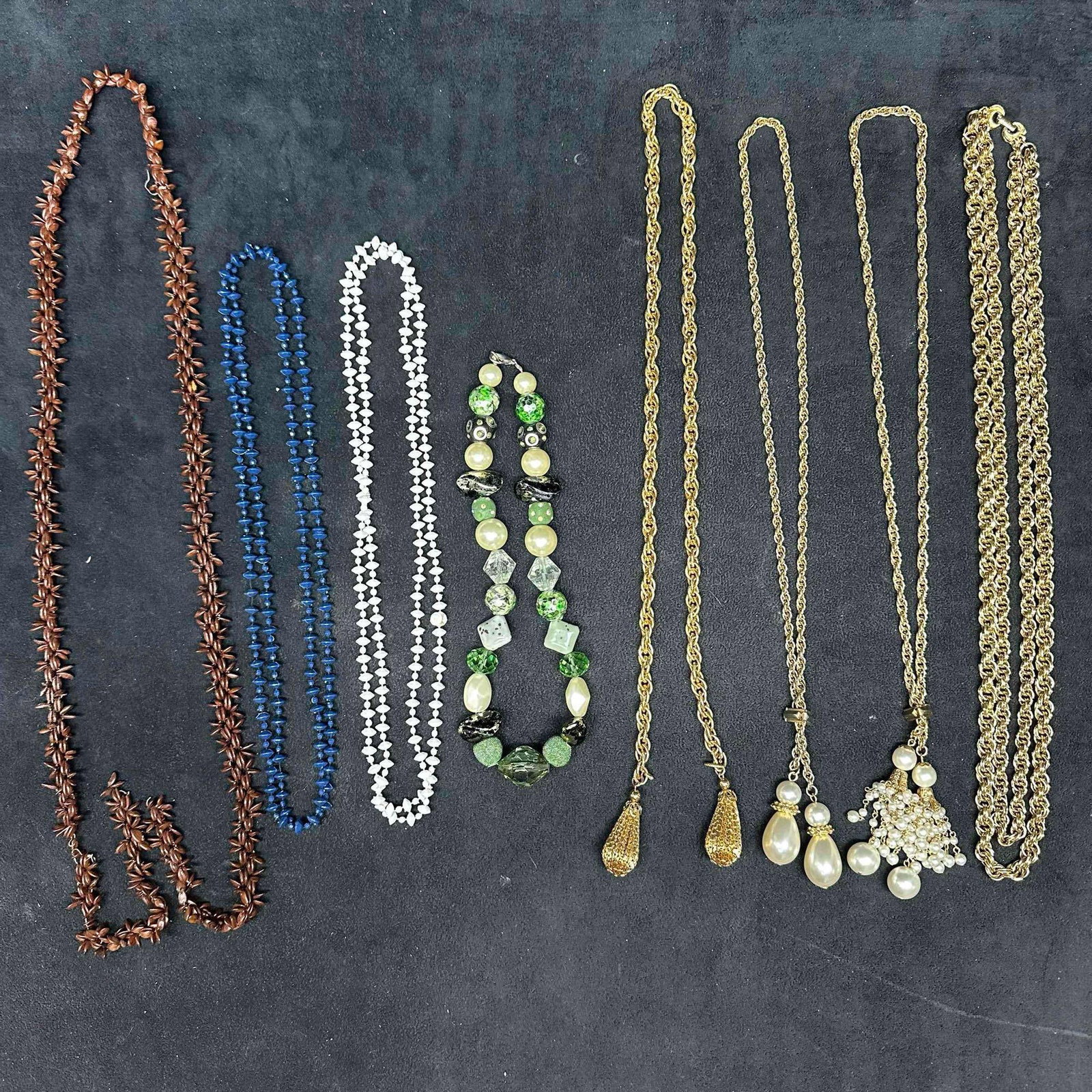 Costume Necklace Collection Plastic Beaded Glass Bead Gold Tone Faux Pearl Jewelry Set: Collection of 8 vintage and costume necklaces in assorted materials and designs. Includes a natural brown seed pod necklace, cobalt blue plastic bead necklace, white beaded strand, and a mixed green g