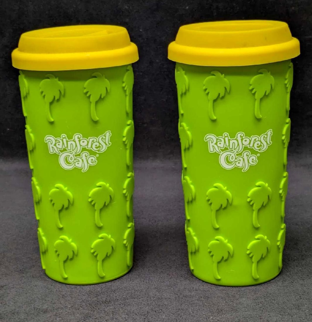 2 Rainforest Cafe Silicone Grip Palm Tree Coffee Tumblers B: 2 Rainforest Cafe Silicone Grip Palm Tree Coffee Tumblers B. Both are ceramic with a silicone wrap for an easy grip. Each is approx 7 3/4" x 3 1/2" x 31/2" and the total weight is 3.01lbs. Both do not