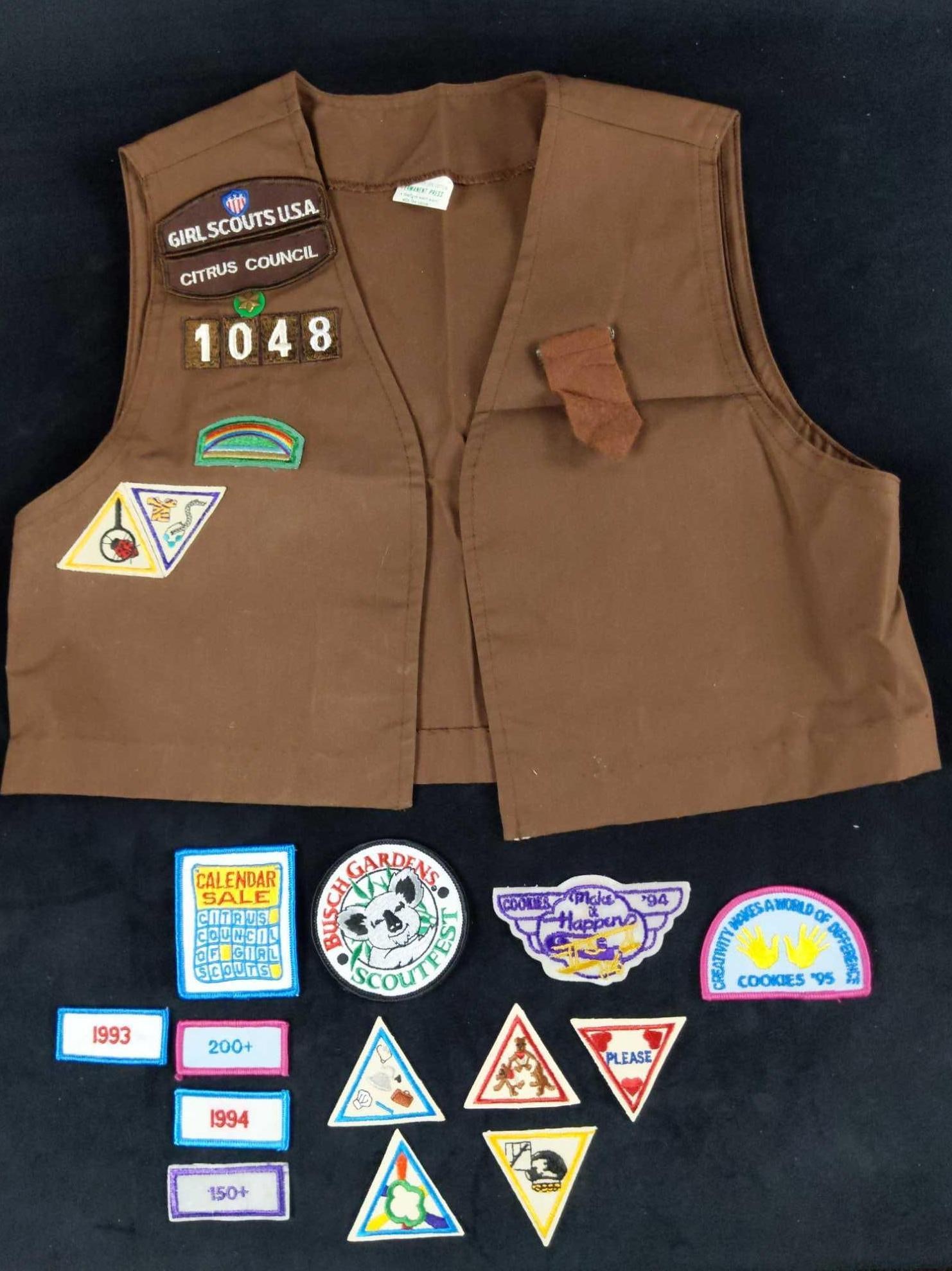 Girl Scout Vest Uniform And Merit Badges 1990s: This scoutly lot includes: (1) Girl Scout Medium Vest (10-12) 65% (Polyester) 35% cotton. (1) Girl Scouts USA - Citrus Council Badge. (1) Star With Green Background (2nd Year) (1) Rainbow 'Bridgin
