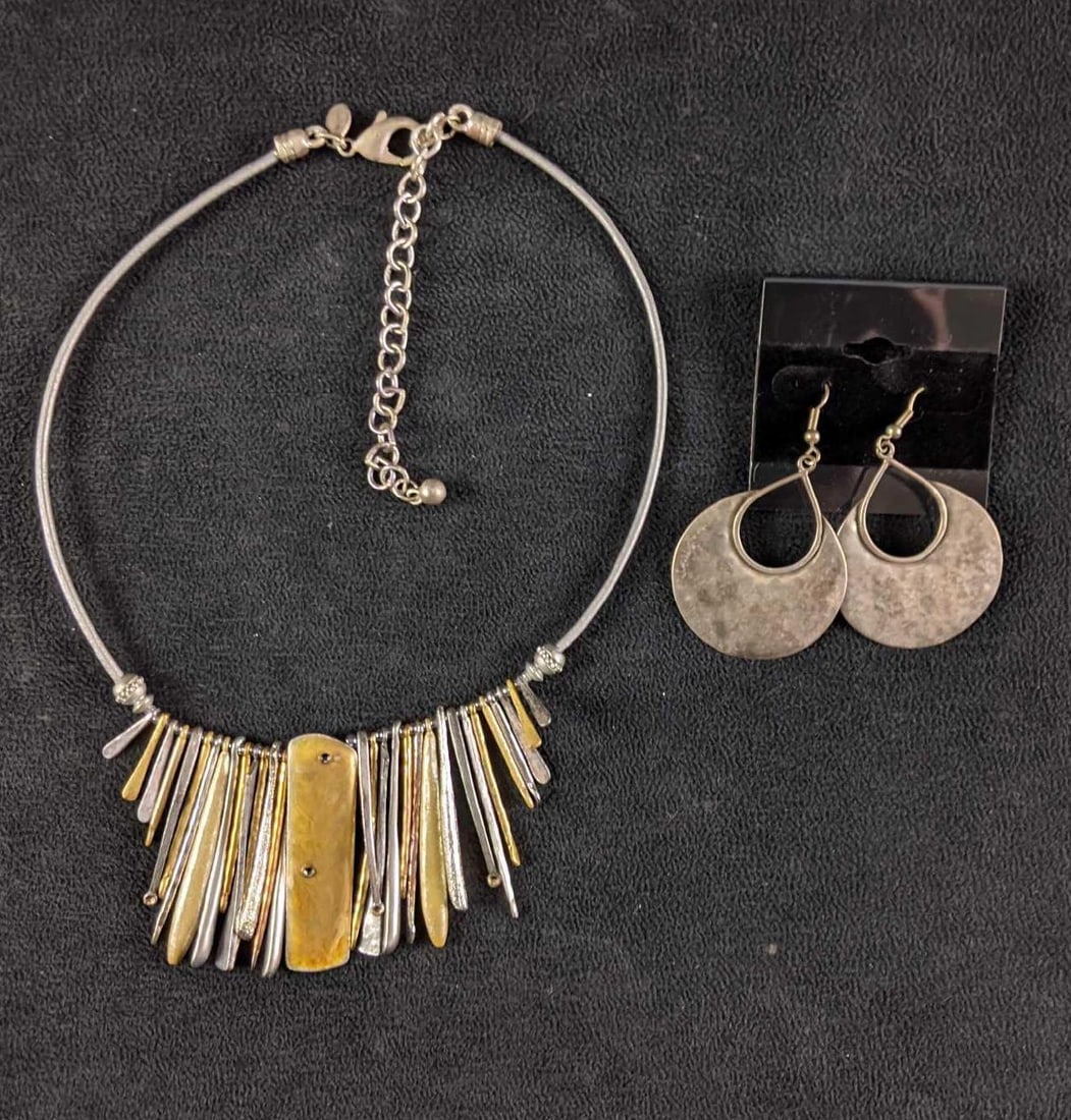 Chico's Necklace With Earrings: Chico's Necklace With Earrings This necklace is silver and gold-colored with matching silver-colored earrings. The earrings are a dangle style and do not come with rubber backings. The jewelry in