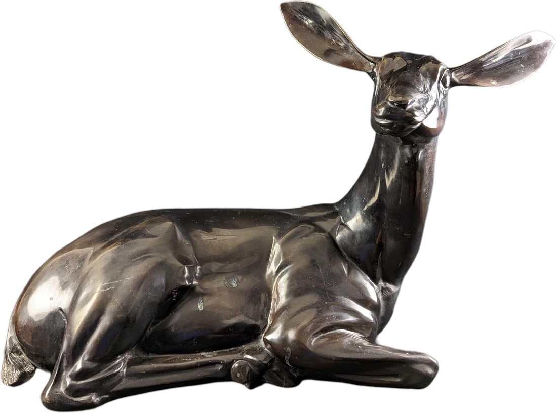 Hattakitkosol Somchai LE Bronze Reclining Deer: Hattakitkosol Somchai Limited Edition Bronze Reclining Deer. This one is #21 out of #100. The bronze deer is approx 25" x 13"x 21" and it weighs 52lbs. The deer is in a good, used