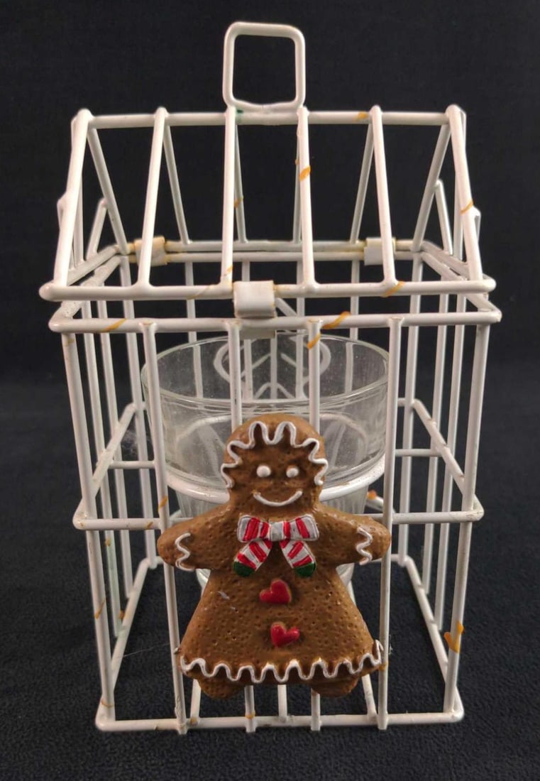 White Wire Gingerbread Candle Holder: Here is a white metal wire Gingerbread 'house' candle holder' that can be hung. Top clips open, where a candle can be placed into and lit. Has a cute gingerbread girl on the front and a tree on the