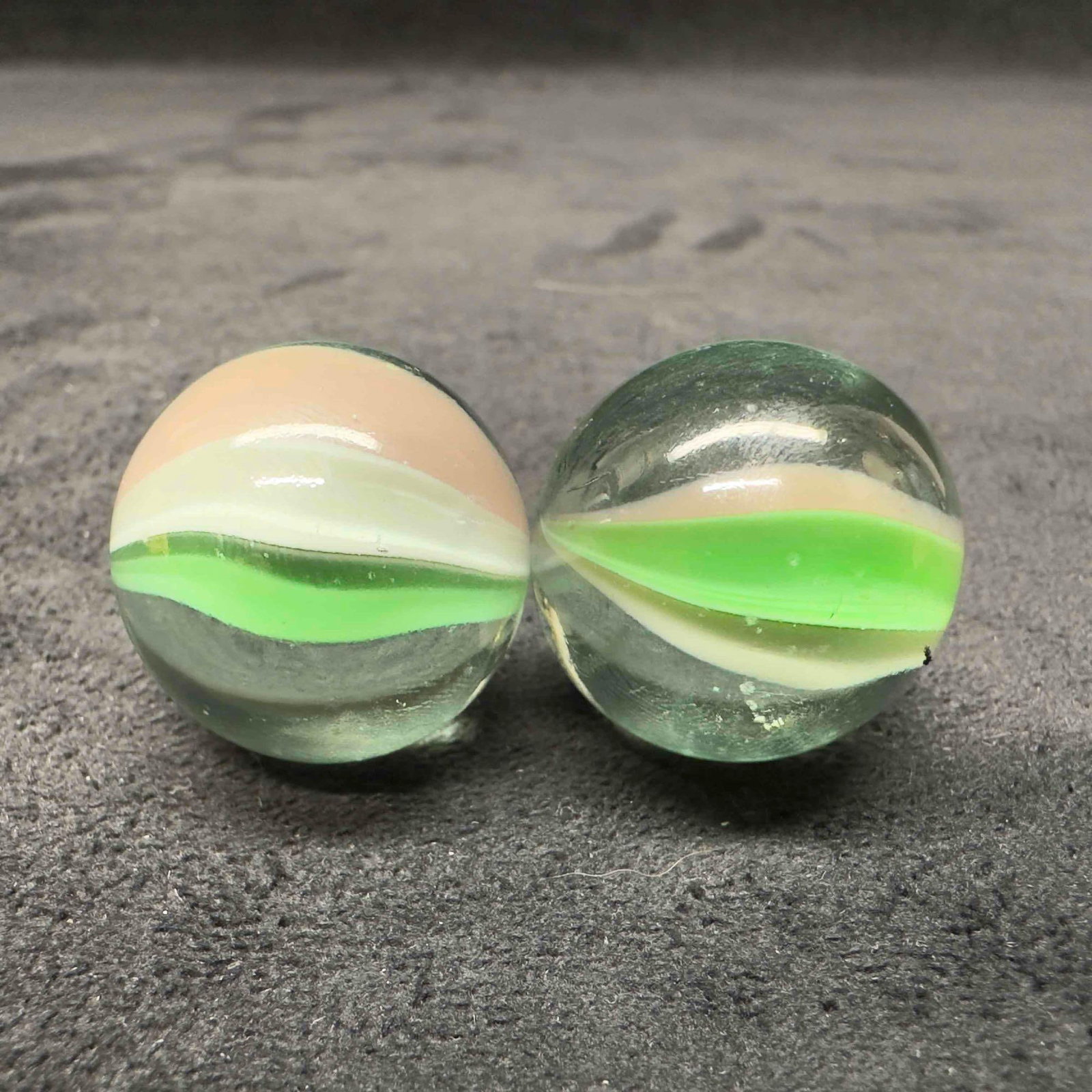 Green Cat Eye Marble Medium 25mm Set: Green Cat Eye Marble Medium 25mm Set. This set of marbles has light marks and a few chips on the glass. These items are in good pre-owned, previously displayed condition with light wear, and surf