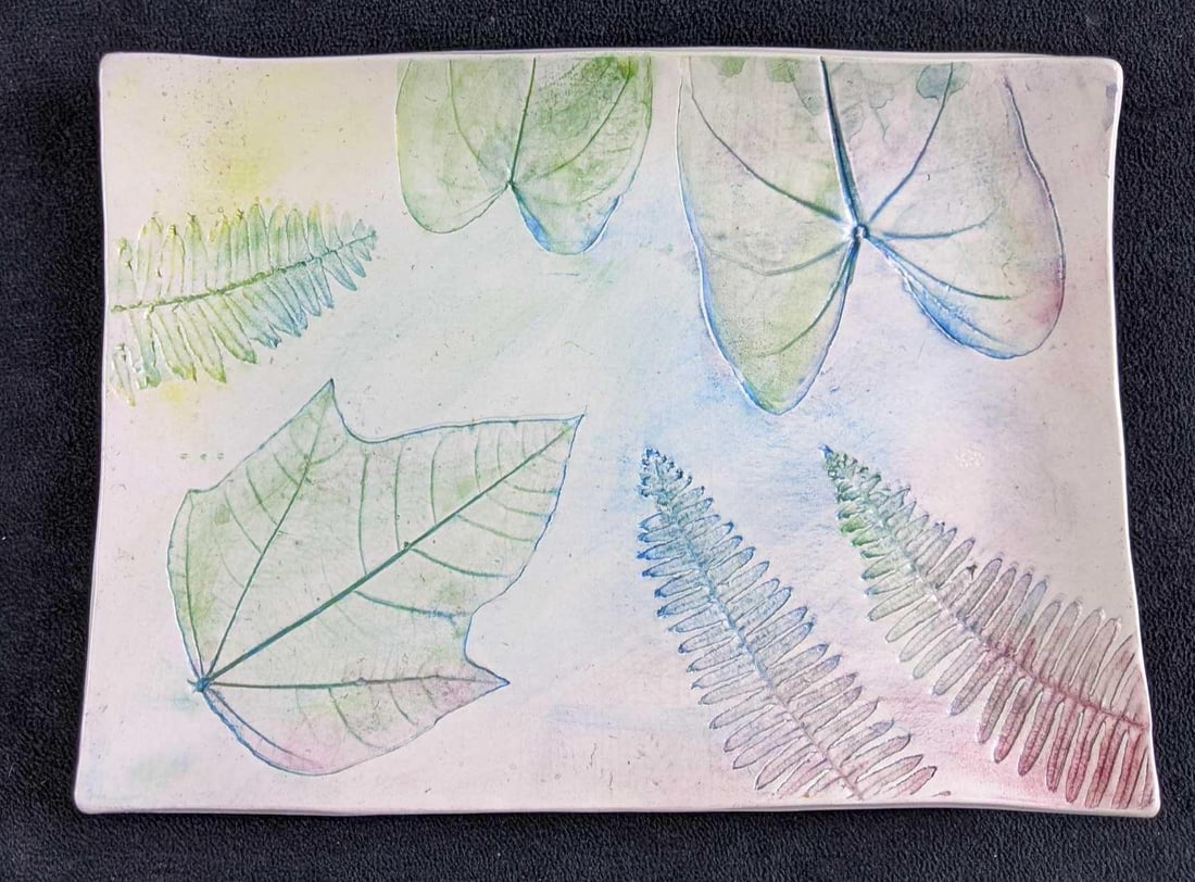 Handmade Decorative Plate: Handmade Decorative Plate This plate is made from white ball clay and has beautiful leaf imprints. There is a light color wash of multiple colors. This is in good condition with no known damage.