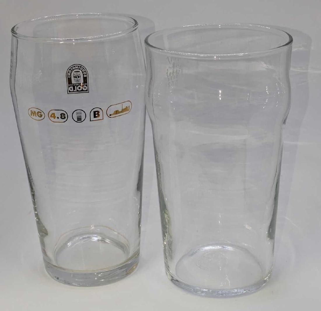 Boddingtons And Arcoroc Glass Pint Glasses: Boddingtons And Arcoroc Glass Pint Glasses. This lot includes: (1) Boddingtons Manchester Gold Pint Glass. This is approx 3 1/4" x 3 1/4" x 6 1/4". (1) Arcoroc French Pint/565 Glass. This