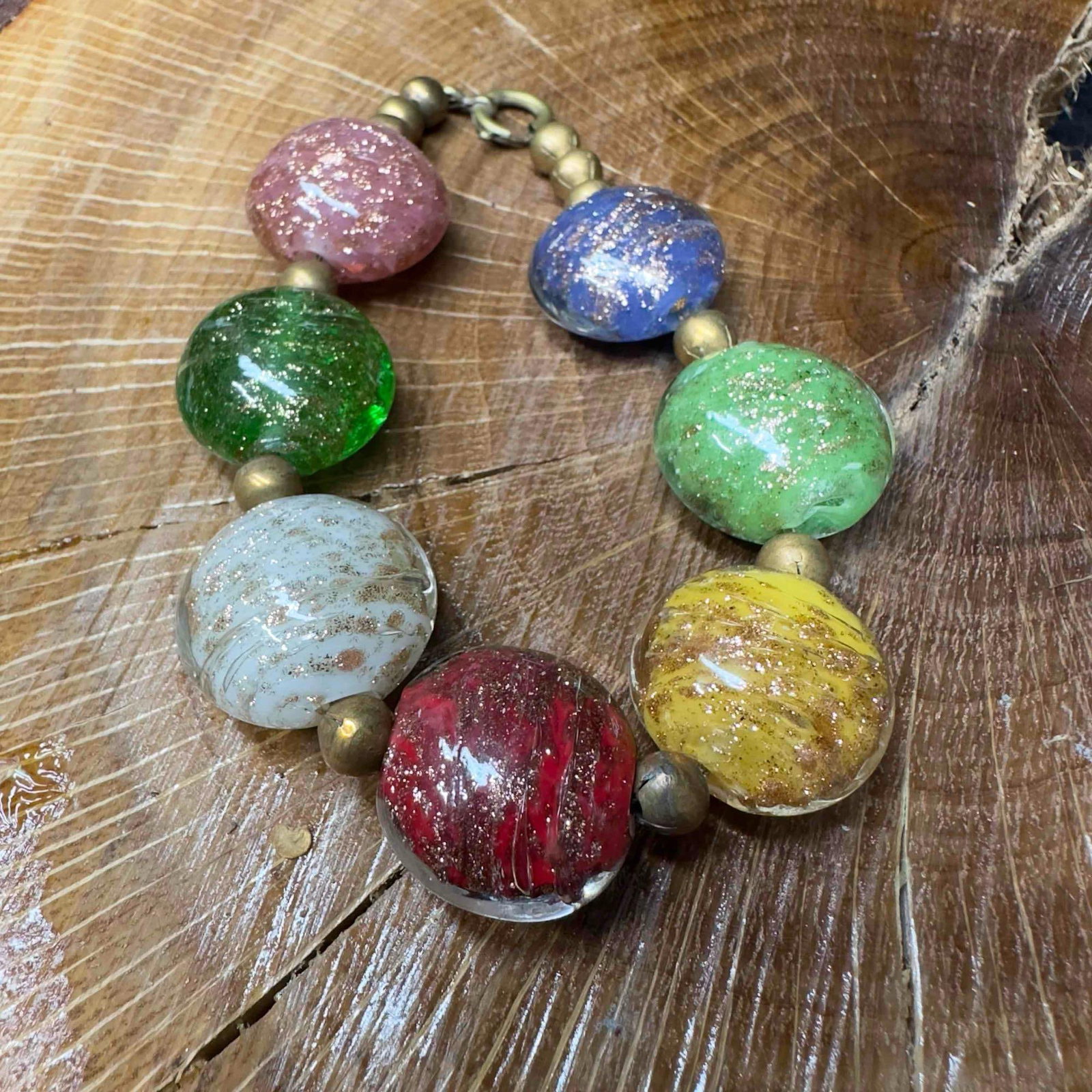 Venetian Murano Lamp Work Glass Multi Colored Round Circle Bead Beaded Bracelet A18: Venetian Murano Lamp Work Glass Multi Colored Round Circle Bead Beaded Bracelet A18. Multi colored glass beads with beautiful designs on each. The bracelet features a spring ring clasp. Seven beads wi