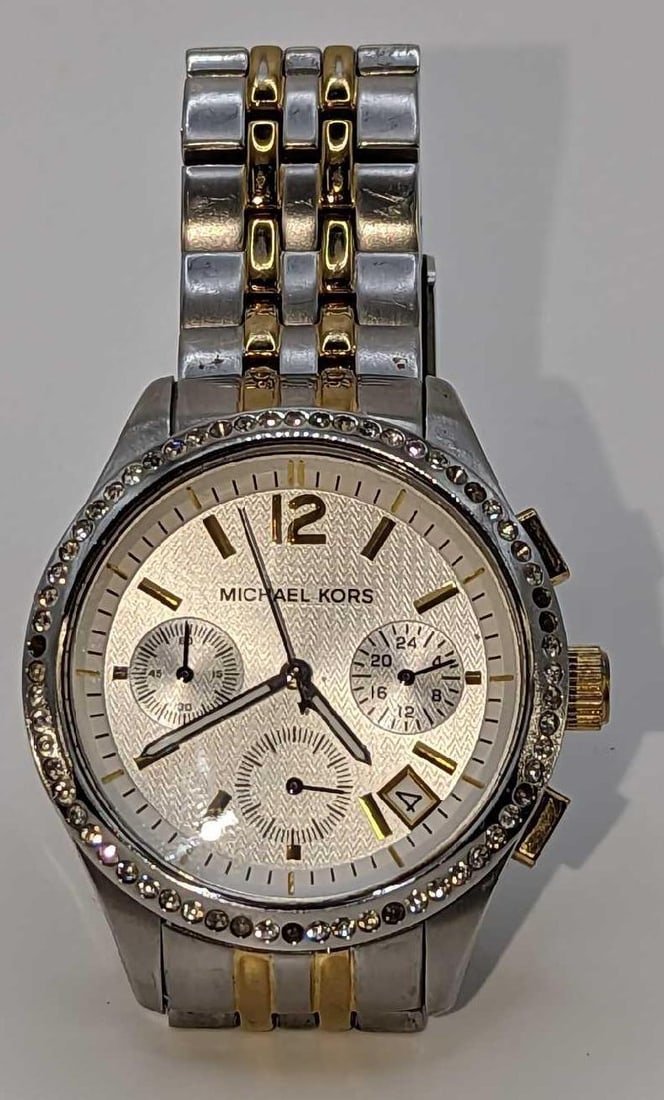 Michael Kors Women's Watch MK5098 - Ritz: Michael Kors Womens Watch MK5098 - Ritz. Is approx 1 3/4" x 3/4" x 3 1/4" and it weighs 0.25lb. The watch requires a new battery and is missing a few stones. Fits a 7-inch 