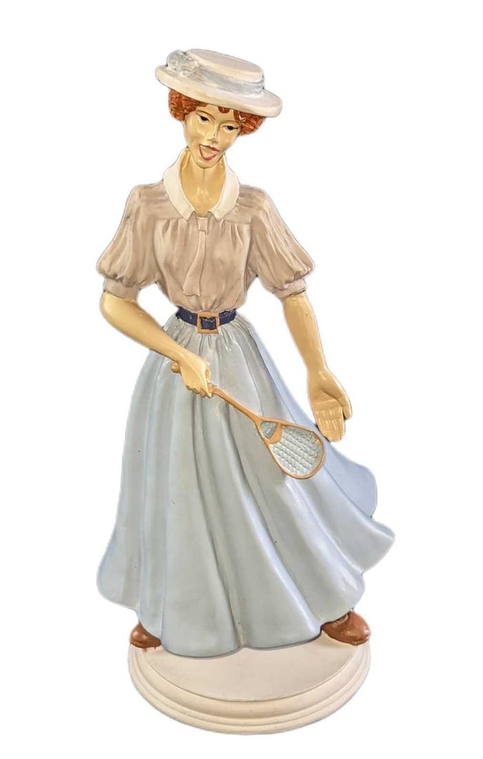 Old Timey Red Head Woman Badminton Player Figurine: Old-Timey Red Head Woman Badminton Player Figurine. Made of resin. The maker and date of creation are unknown. The figurine is approx 4" x 3" 8 1/2" and it weighs 1.18lb. The figurine is in a good, us