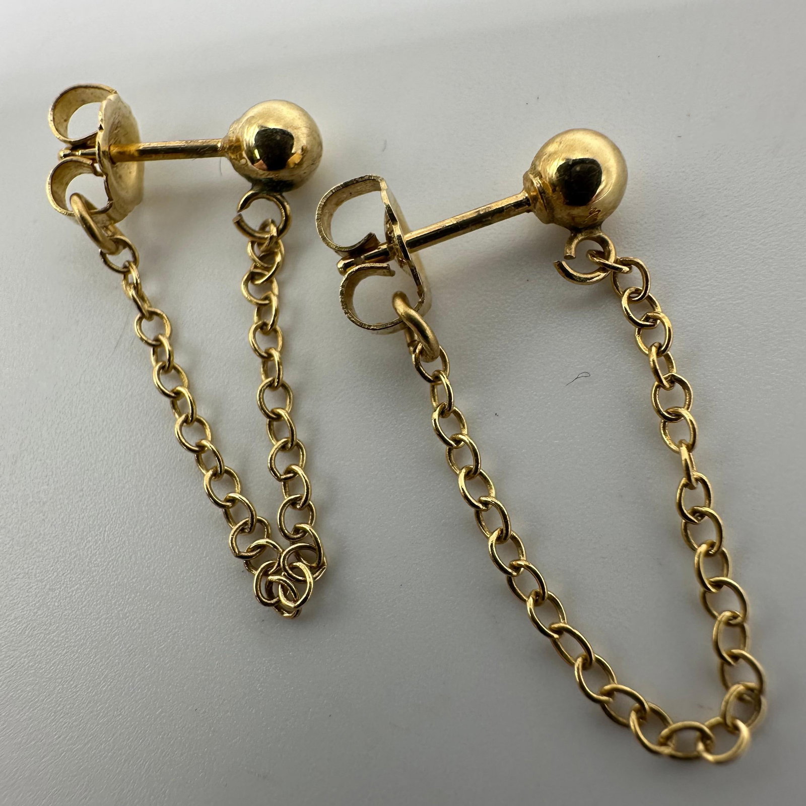 14K Gold Ball Stud Front to Back Chain Dangle Earrings W45: This item is in good pre-owned, previously used/displayed condition with noticeable light wear and surface scratches. Please reference all photos for full details. This piece of jewelry has been