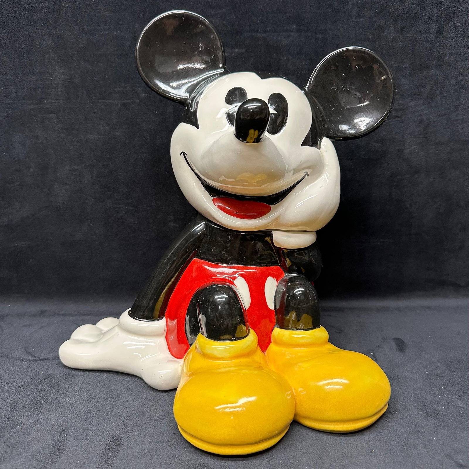 Disney Treasure Craft Mickey Mouse Cookie Jar Sitting Figure Mexico Ceramic: Vintage Disney Treasure Craft Mickey Mouse ceramic cookie jar, featuring Mickey in a seated pose with bright yellow shoes, red shorts, and a classic smiling expression. Two-piece design with removable