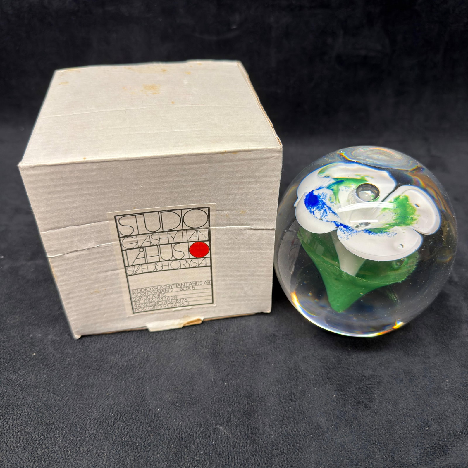 Art Glass Paperweight Studio Ahus Sweden Floral Abstract ER63: Studio Ahus art glass paperweight featuring a clear spherical form with an internal abstract composition in green, white, and blue glass. Designed and produced in Sweden. Retains original Studio Ahus 