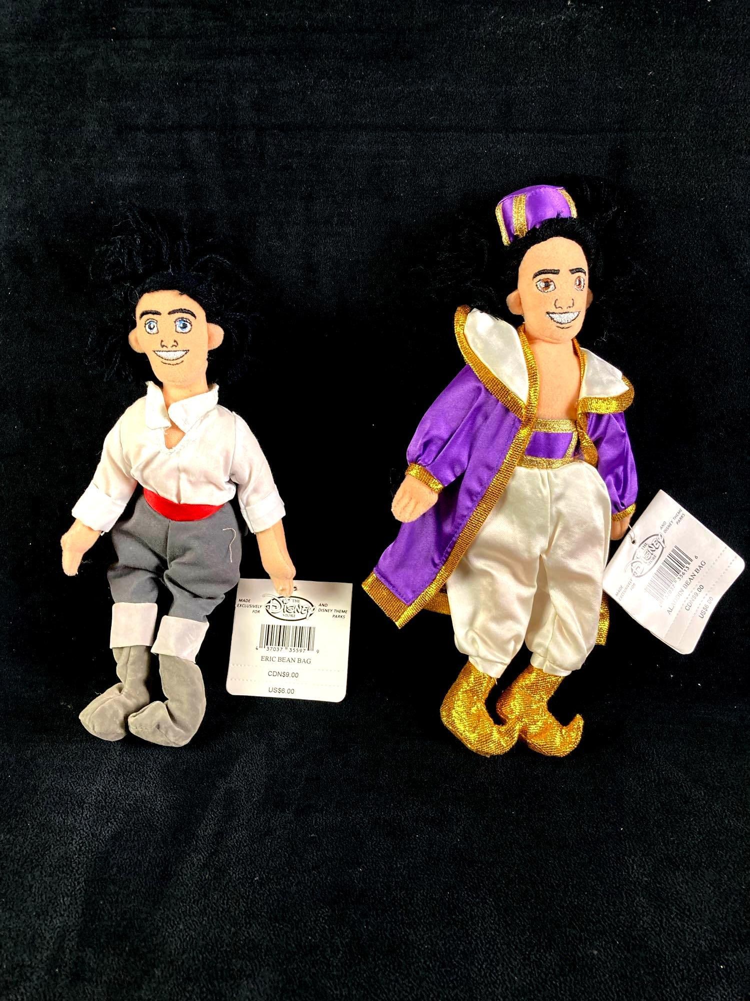 Set of (2) Disney Plush Bean Bag Dolls Aladdin and Eric: Up for auction is a recent estate find, a set of (2) Disney plush bean bag dolls in particular Aladdin from the Disney film Aladdin and Eric from The Little Mermaid. These came from a twenty year coll