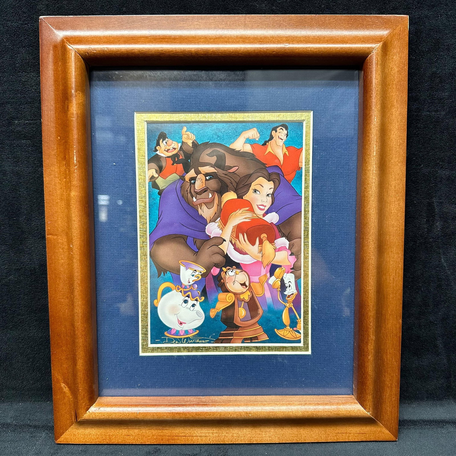 Beauty and the Beast Don Williams 10th Anniversary Art Print Brown Wood Frame: Framed Disney Beauty and the Beast animation art print featuring Belle, Beast, Gaston, Mrs. Potts, Chip, Cogsworth, and Lumiere in a vibrant scene. Presented under glass in a wood frame with double ma