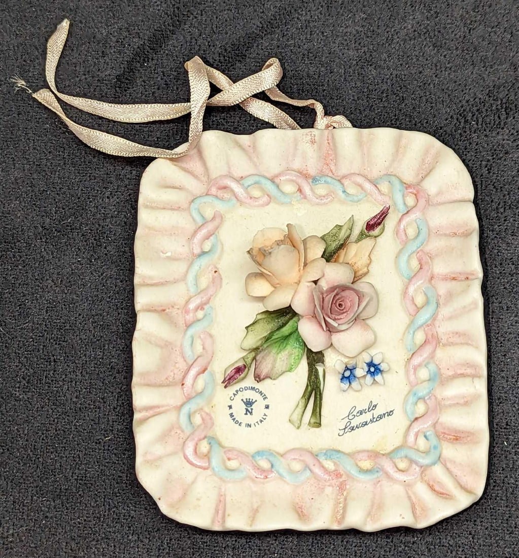Capodimonte Plaque Pink Floral With Ruffled Edges: Capodimonte Plaque Pink Floral With Ruffled Edges. Made in Italy. Is approx 3 1/2" x 1 1/4" x 4 1/2" and it weighs 0.29lb. The flowers have chips and there are markings. Please see the images as 