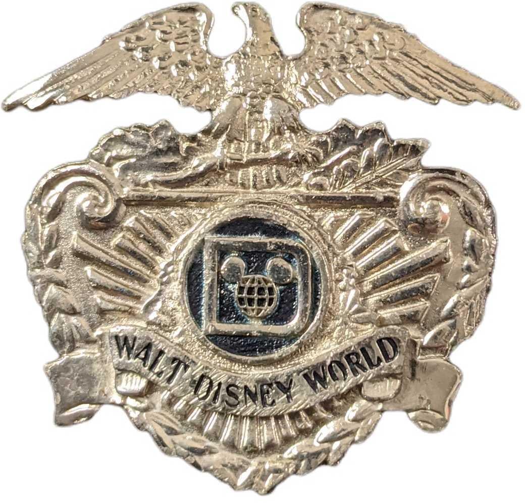 1970s/1980s Walt Disney World Security Hat Badge: This badge adorned the hat of the Walt Disney World Park Security Employees during the 1970's/1980s. The back of the badge has two threaded prongs that fit through two holes in the hat and were secure