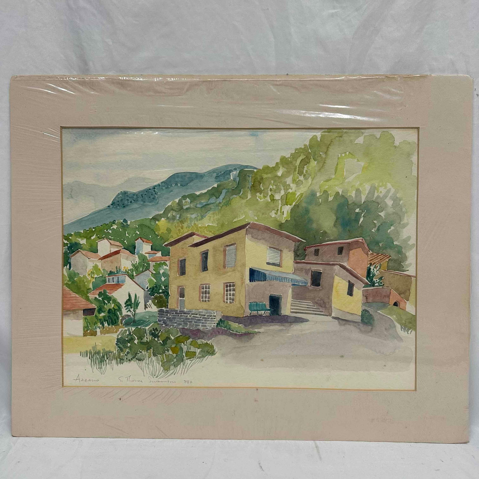 Thorne Swanson Watercolor Azzano Italian Village Scene 3/80: Watercolor painting by Thorne Swanson, titled Azzano. The piece captures a quiet Italian village with sunlit houses, lush greenery, and rolling mountains in the background. Signed and numbered by the 