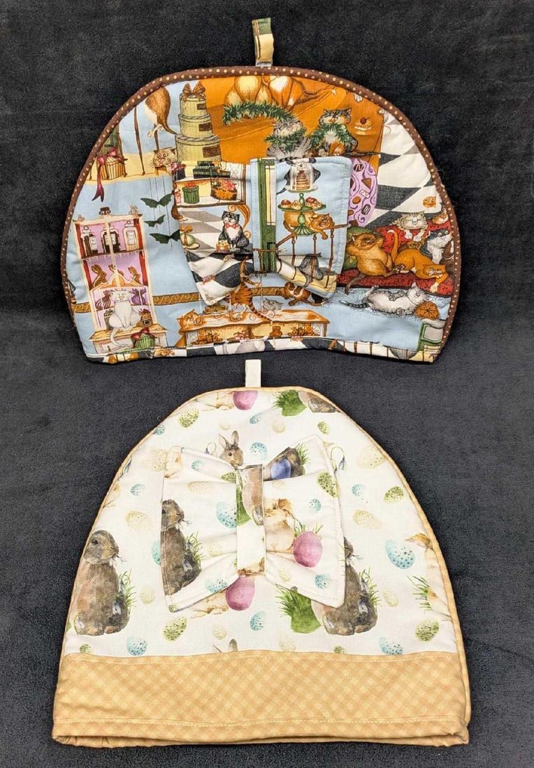 2 Cats And Rabbit Easter Print Cozy: 2 Cats And Rabbit Easter Print Cozy. The cat print cozy is approx 11" x 13 1/2" x 1" and the Easter/Rabbit cozy is approx 12" x 10 1/2" x 1". The total weight is 0.44lb. Both do not have any damage.