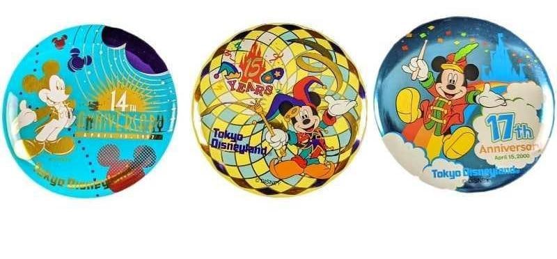 3 Tokyo Disneyland Anniversary Buttons: This lot consists of 3 Tokyo Disneyland Anniversary Buttons. Each 3 1/4". Each is from the 14th, 15th and 16th anniversaries. The total weight is 0.16lb. There is some markings on the 14th