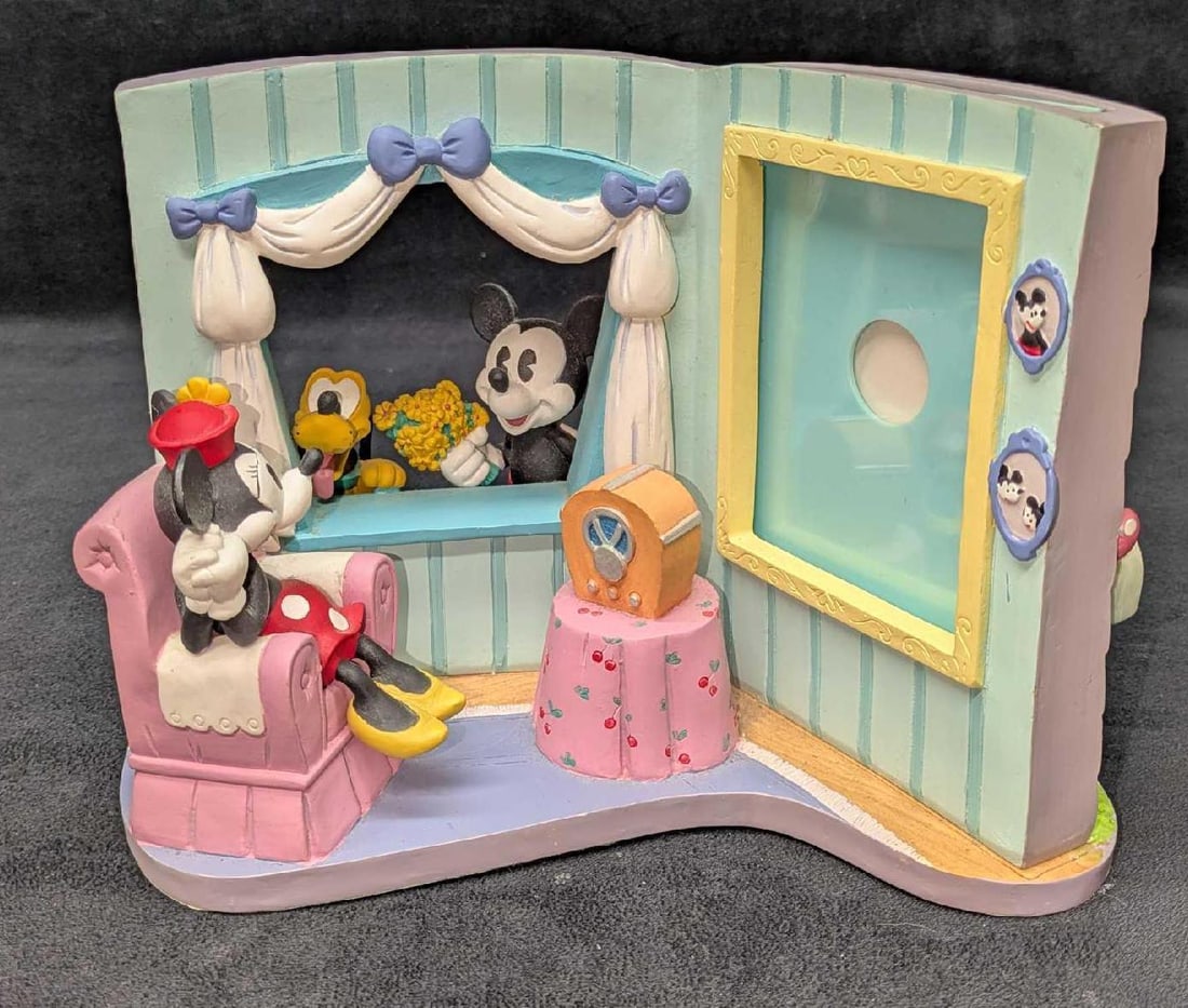 Disney Mickey Mouse And Friends 3D Picture Frame: Disney Mickey Mouse And Friends 3D Picture Frame. Made of resin. This is approx 6 7/8" x 10" x 7" and it weighs 4.30lbs. The easy to slide out picture frame fits an 5" x 3 1/2" photo. Please see the