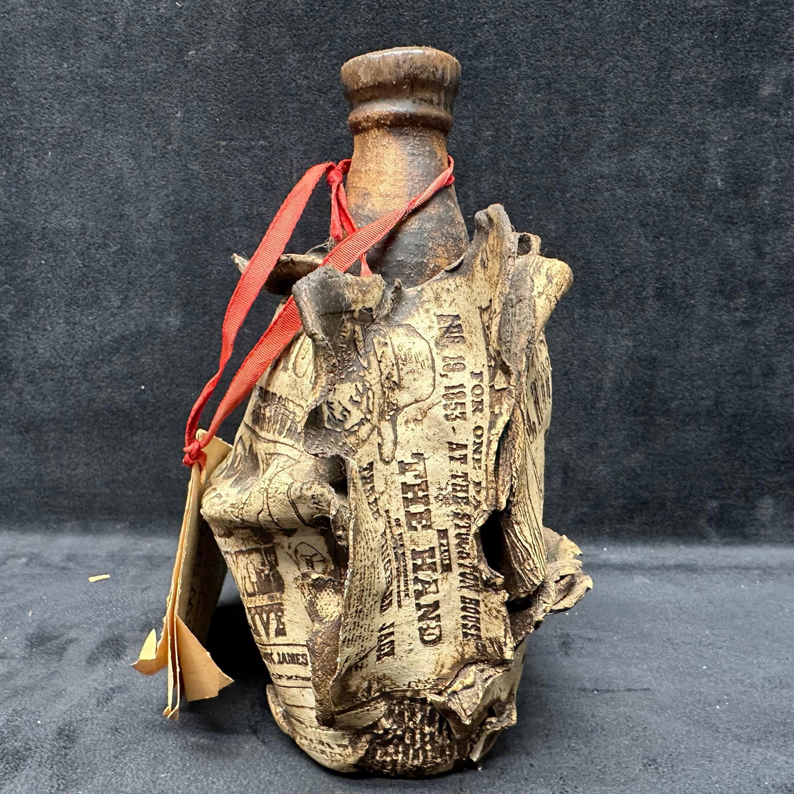 Ron Krogh New Spots High Fire Pottery Jug Jesse James Poster Headlines Inlaid in Clay: Unique, New Spots, ceramic jug sculpture by Ron Krogh, from his High Fire Pottery Lab in North Salt Lake, Utah. This piece features historical newspaper headlines and wanted posters, including referen