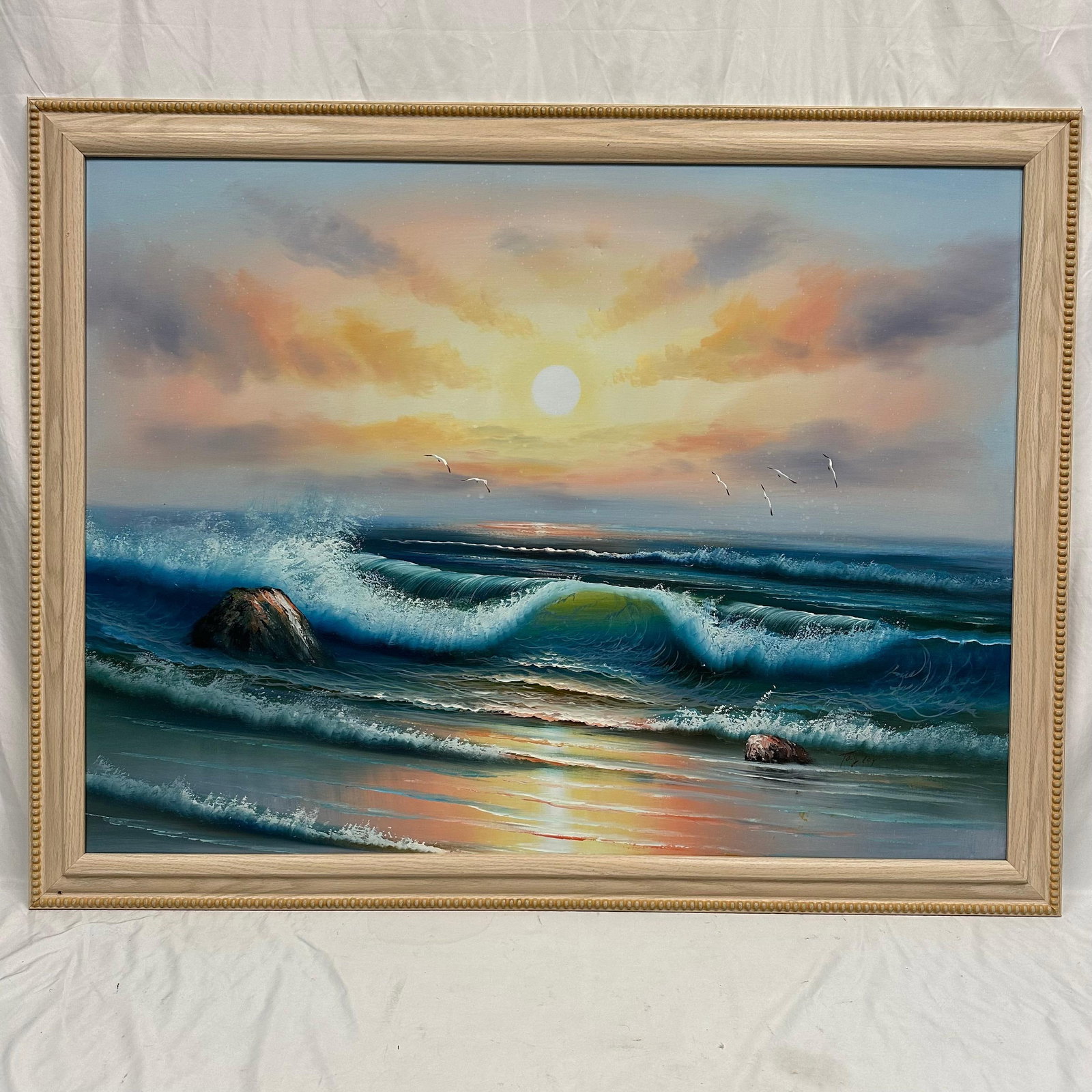 Signed Seascape Oil Painting on Canvas Sunset Ocean Waves with Seagulls: Original oil painting on canvas signed by, unknown artist, depicting a coastal sunset with rolling ocean waves, rocks, and seagulls in flight. Presented in a light wood frame with beaded edge detail. 