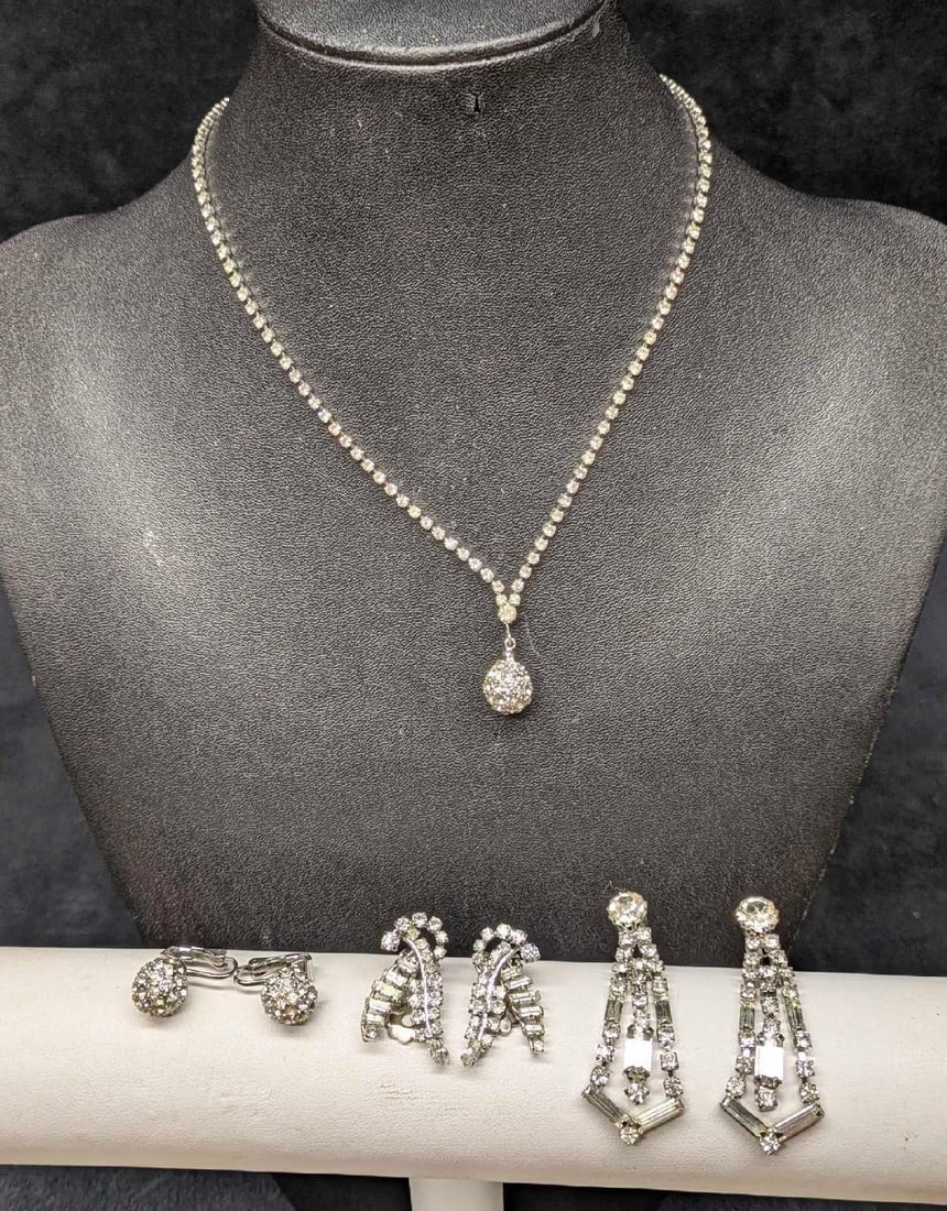 Vintage Silver Tone Unsigned Rhinestone Necklace And Earrings Lot Of 4: This lot includes: (1) Unsigned Rhinestone Silver Tone "Fireball" Pendant Necklace. This is 16". (1) Set Of Unsigned Rhinestone Silver Tone "Fireball" Clip On Earrings. Each is app