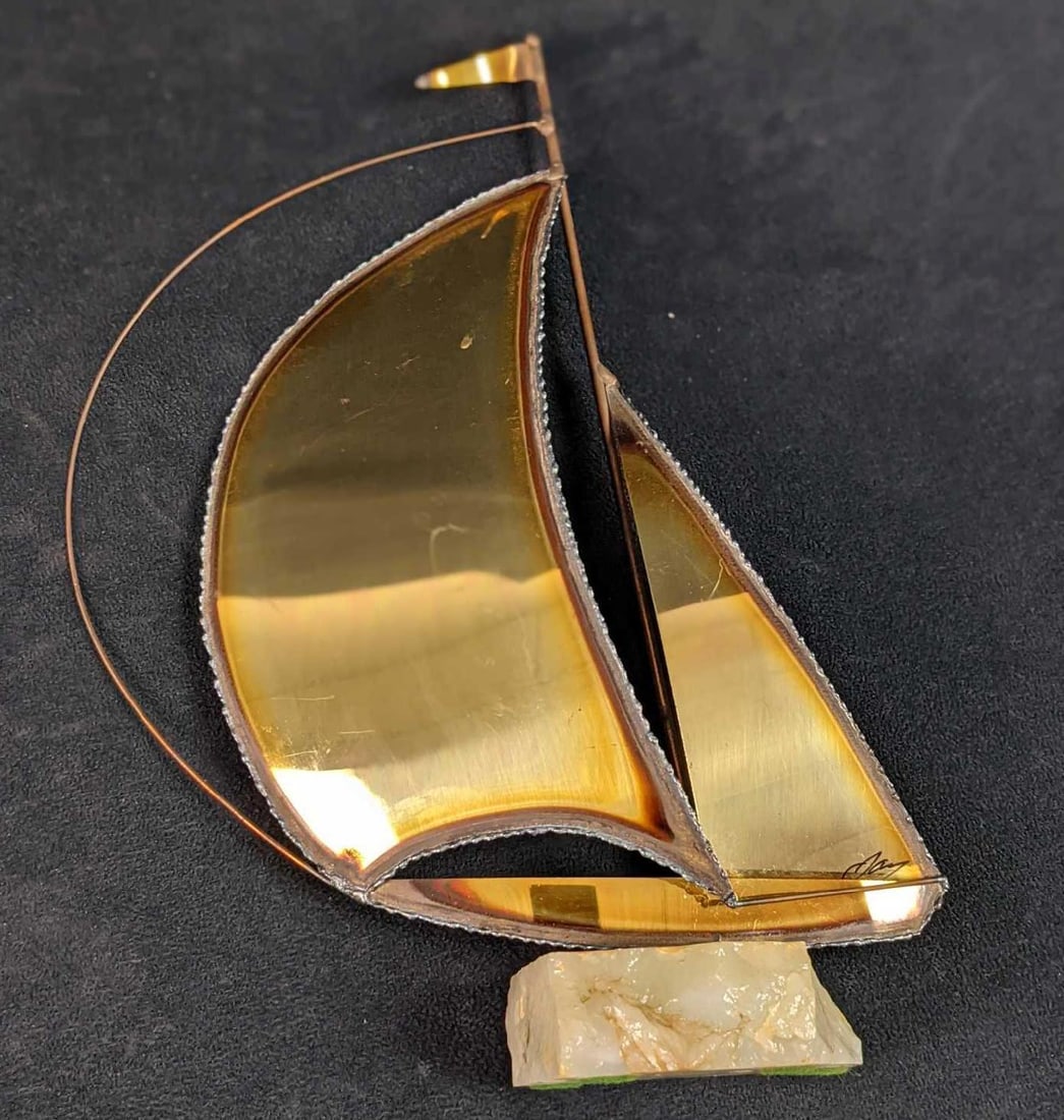 Small Brass Sailing Ship Similiar To Demott B: Small brass sailing ship, very similar to the ones Don Demott would make in the 1970s. These are signed, but they do not appear to be Demott. The ship is mounted on a stone. Is approx 8" x 2 1/2" x 11