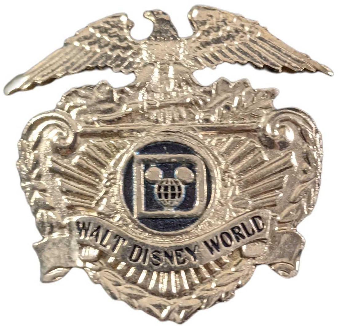 1970s/1980s Walt Disney World Security Hat Badge: This badge adorned the hat of the Walt Disney World Park Security Employees during the 1970's/1980s. The back of the badge has two threaded prongs that fit through two holes in the hat and were secure