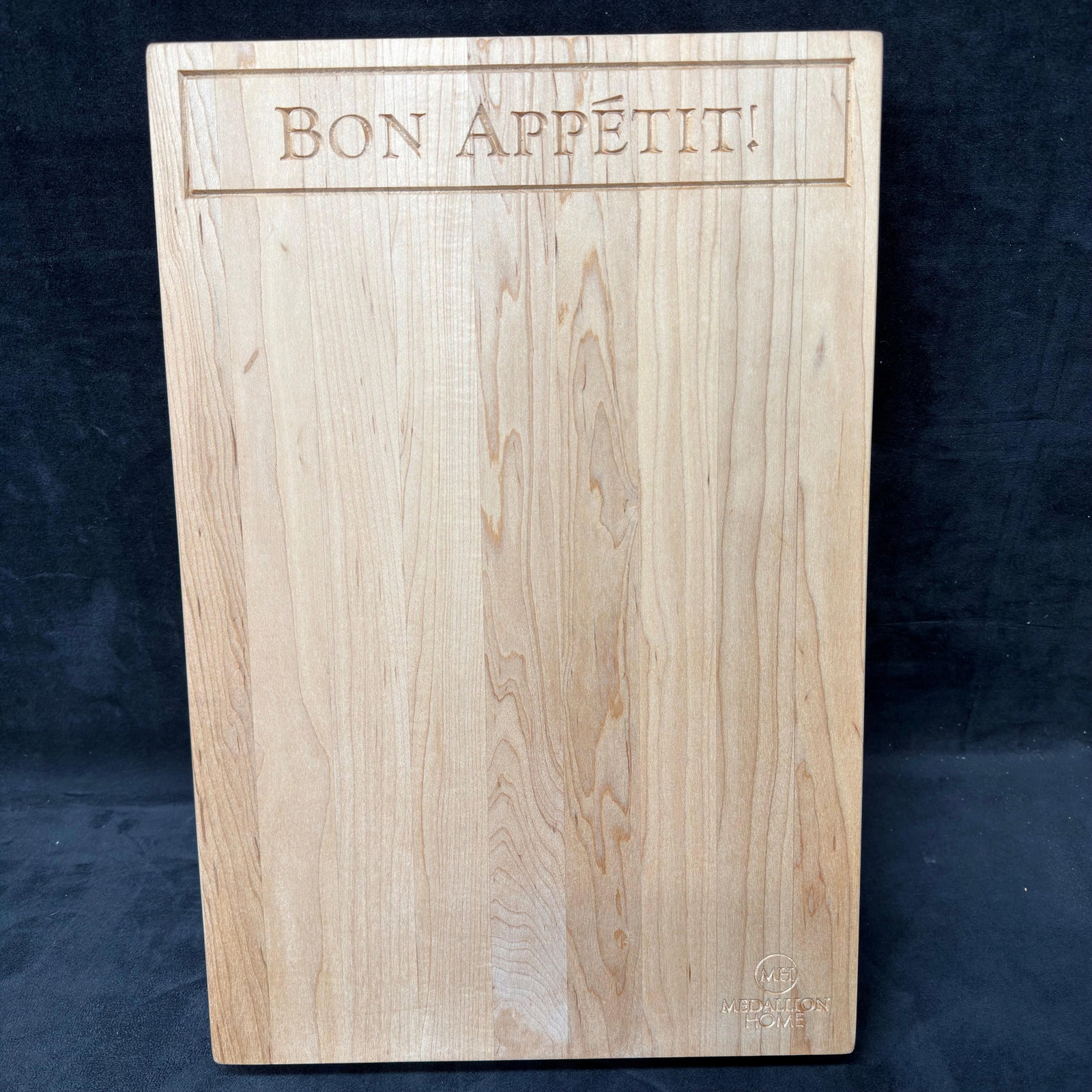 Bon Appetit Solid Wood Engraved Medallion Home Cutting Board: Medallion Home solid wood cutting board featuring a carved "Bon Appetit!" inscription across the top and the Medallion Home logo engraved in the lower corner. Includes the original presentatio