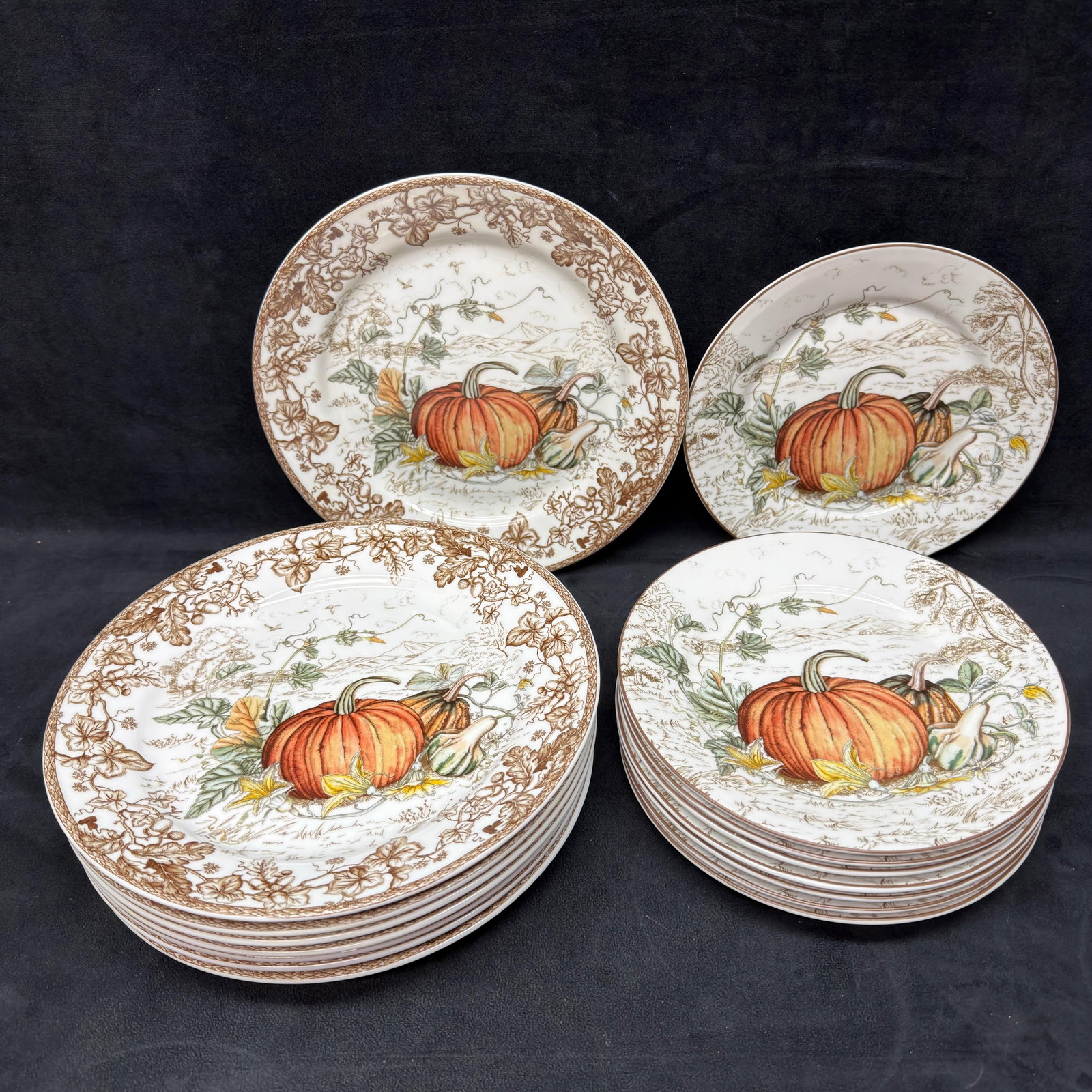Set of Sixteen Williams Sonoma Plymouth Pumpkin Dinner and Salad Plate Thanksgiving: Williams Sonoma harvest-themed porcelain dinnerware featuring a pumpkin and gourd landscape design with an oak leaf and vine border. This lot includes 8 dinner plates and 8 salad plates (16 pieces tot