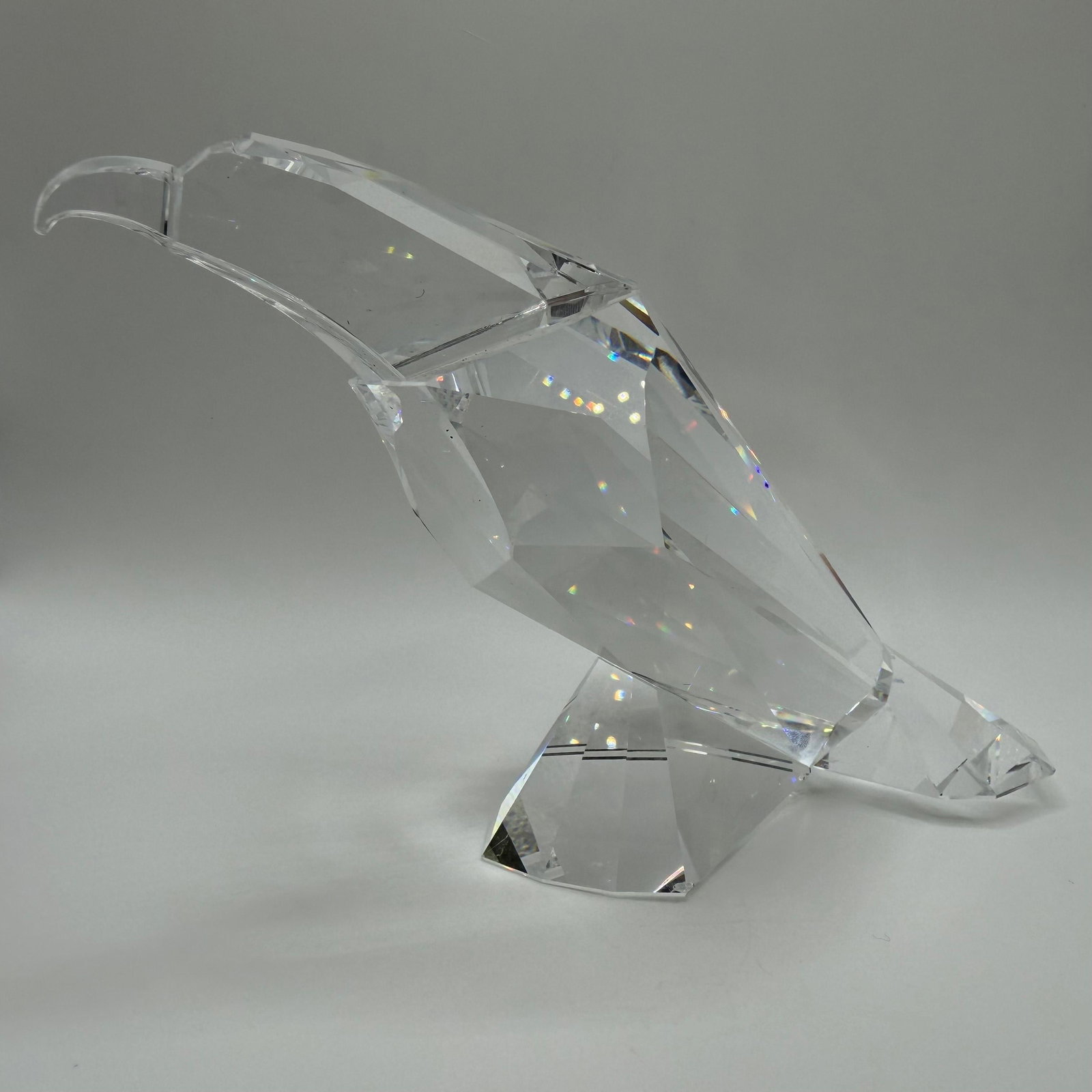 Swarovski Crystal Eagle Figurine Retired Faceted Bird Swan Logo R240: Retired Swarovski crystal glass art eagle figurine featuring the brand's iconic fully faceted design with frosted eyes and an etched Swarovski swan logo on the underside. Please note there are sma