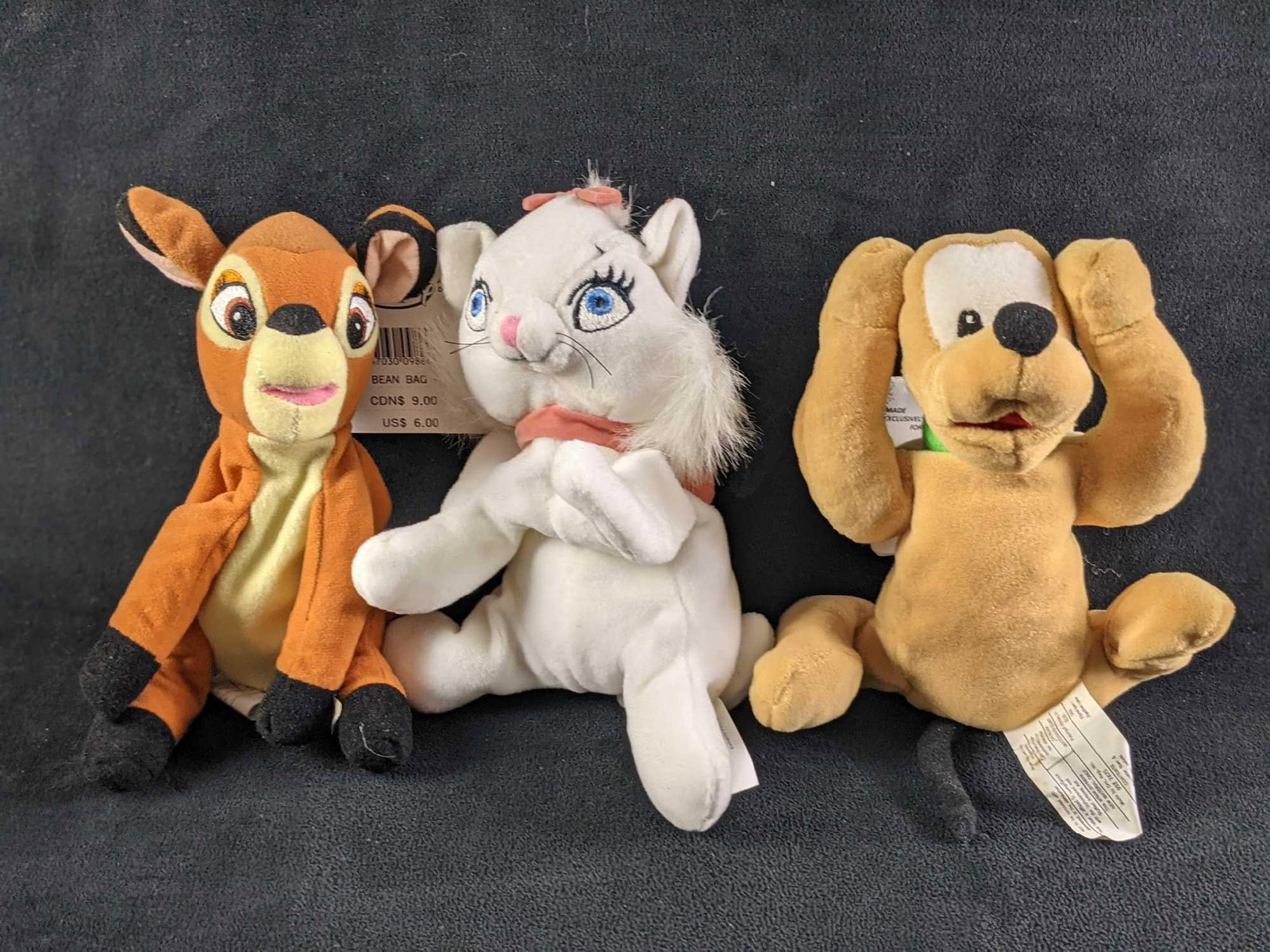 Disney Bambi Pluto Marie Pluto Mini Bean Bag Dolls: This lot includes: (1) Marie Kitten From Disney's Aristocats. Is approx 4" x7" x 4". Has some markings on her right side. (1) Pluto. Is approx 6" x 8" x 3". Tag has so