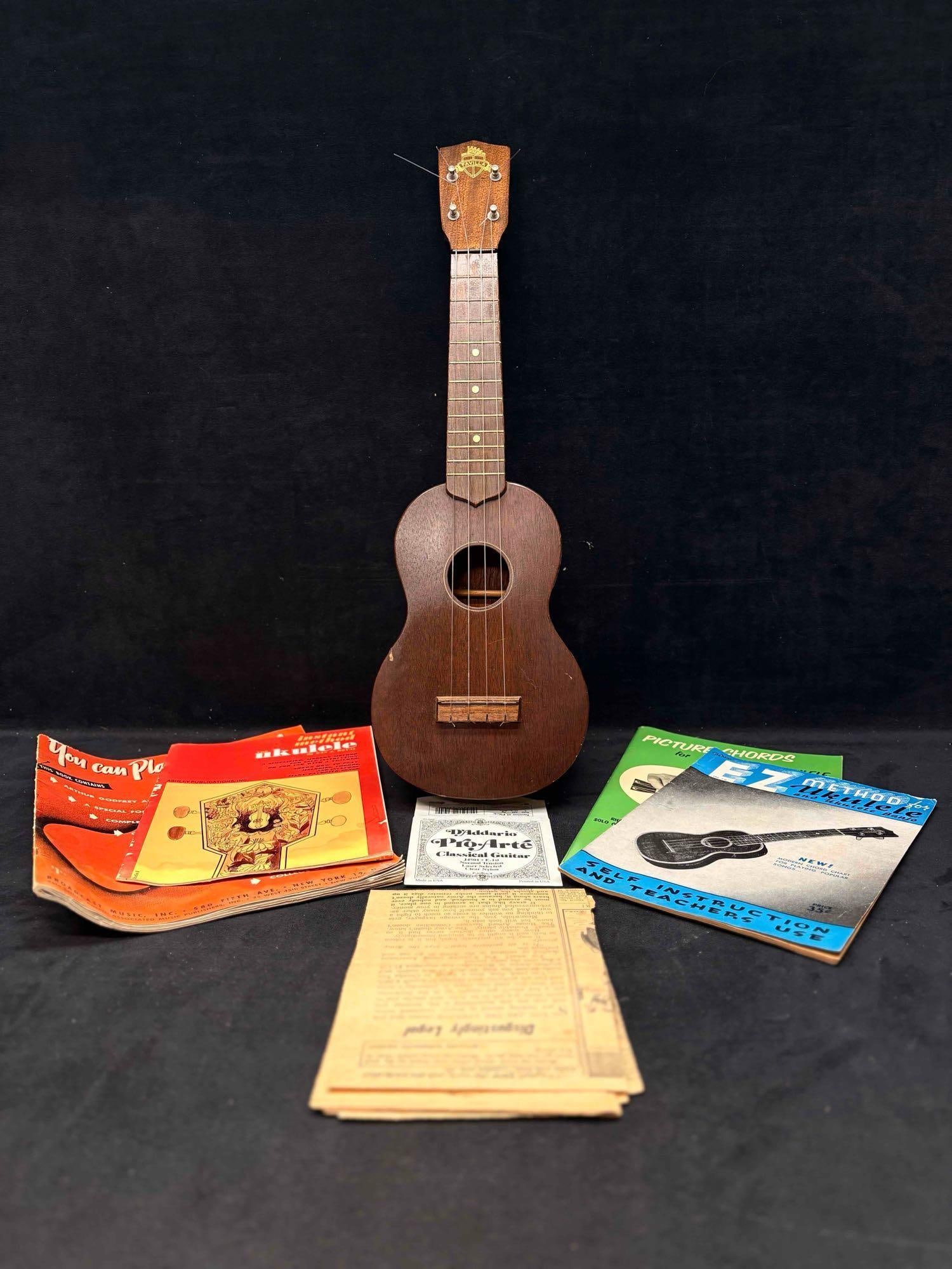 1950s Favilla Mahogany Ukulele with 1940s to 1950s Published Ukulele Lessons: This lot is a vintage all-you-need bundle for playing the Ukulele. Not only does it include the instrument (please review images for context of its conditions), but published Ukulele lessons rang