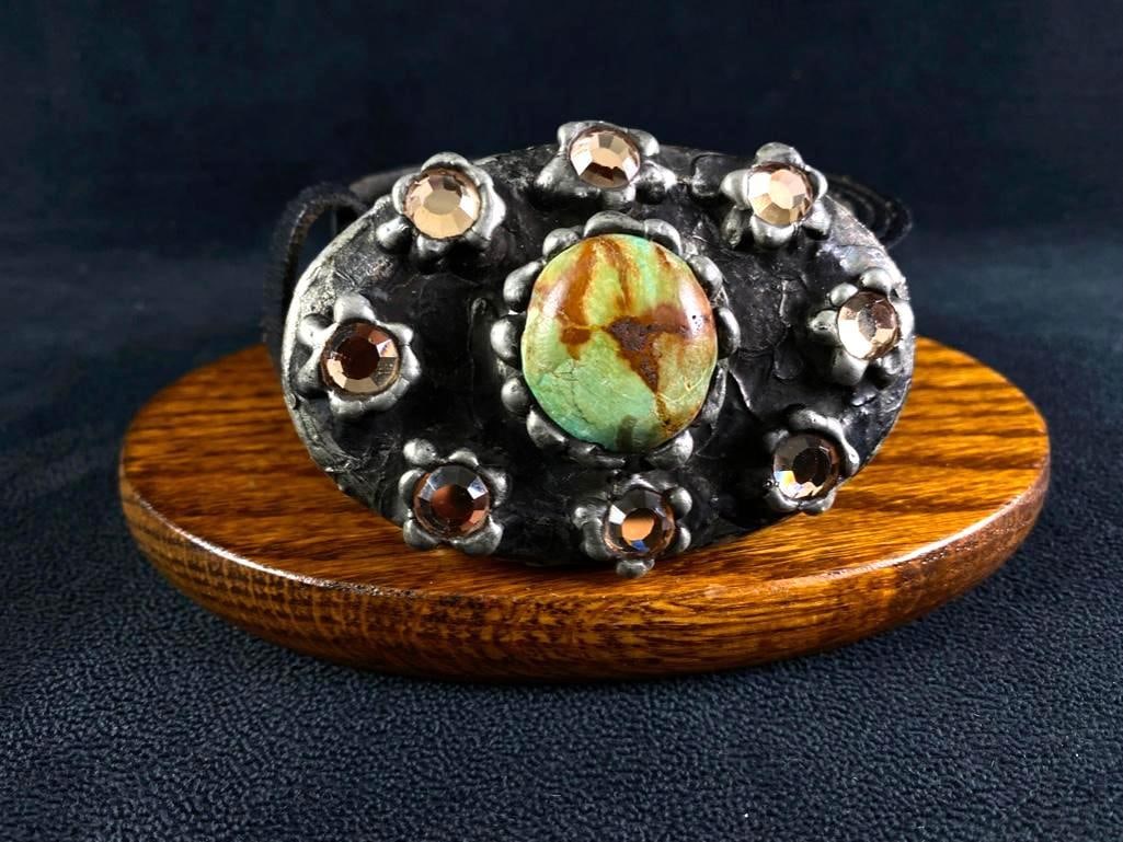 Mikal Winn "Midnight" Belt Buckle w/ Green Onyx: Mikal Winn "Midnight" Belt Buckle w/ Green Onyx Belt by famed designer Mikal Winn in 2002. The front of the buckle features a green onyx stone in the center, surrounded by orange crystals