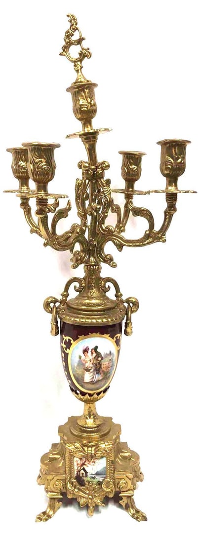 Modern Reproduction Of Lancini Candelabra: This lot contains a modern reproduction of the classic antique candelabra originally made by artist Lancini and the Hermle company. This reproduction is brass plated and made with porcelain. The cande