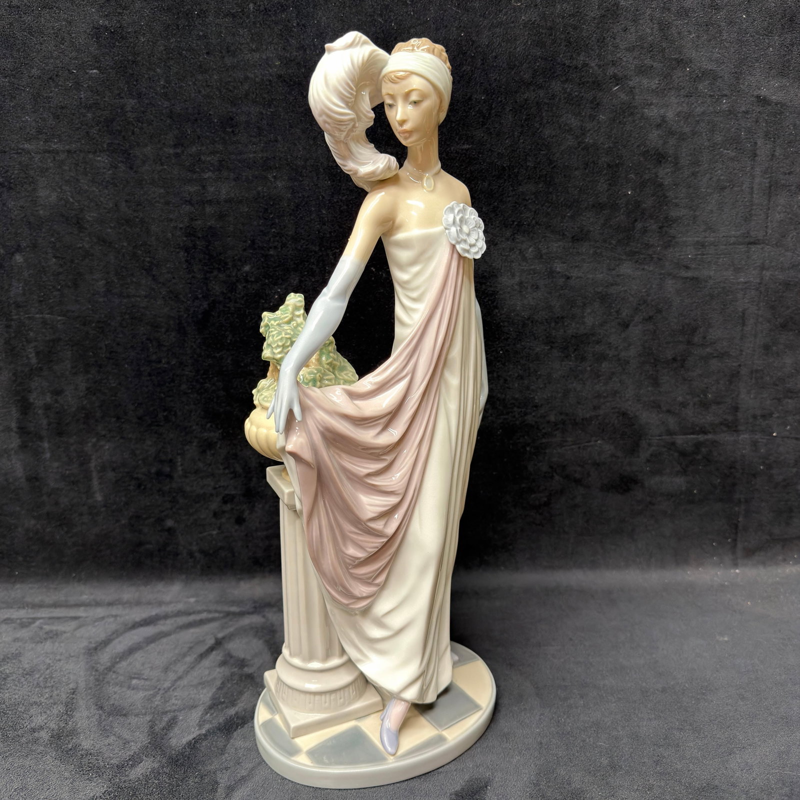 Lladro 5283 Elegant Lady with Pedestal Porcelain Figurine Socialite of the 20s: Authentic Lladro porcelain figurine, model 5283, handcrafted in Spain. This graceful figure features an elegantly dressed woman wearing a flowing white and blush gown with long gloves, posed