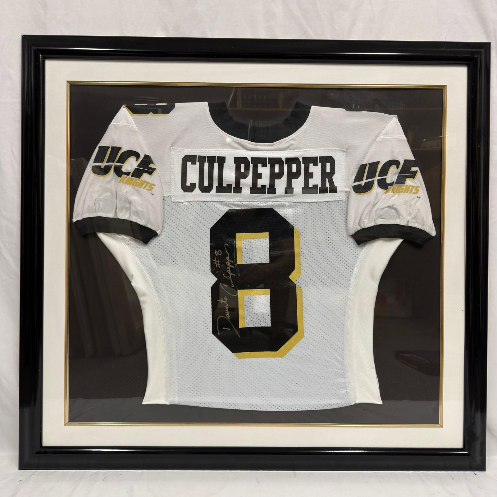 Framed Daunte Culpepper Signed UCF Knights Football Jersey Display R240: Framed University of Central Florida (UCF) Knights football jersey featuring the nameplate Culpepper and number 8, hand-signed by former UCF standout and NFL quarterback Daunte Culpepper with an