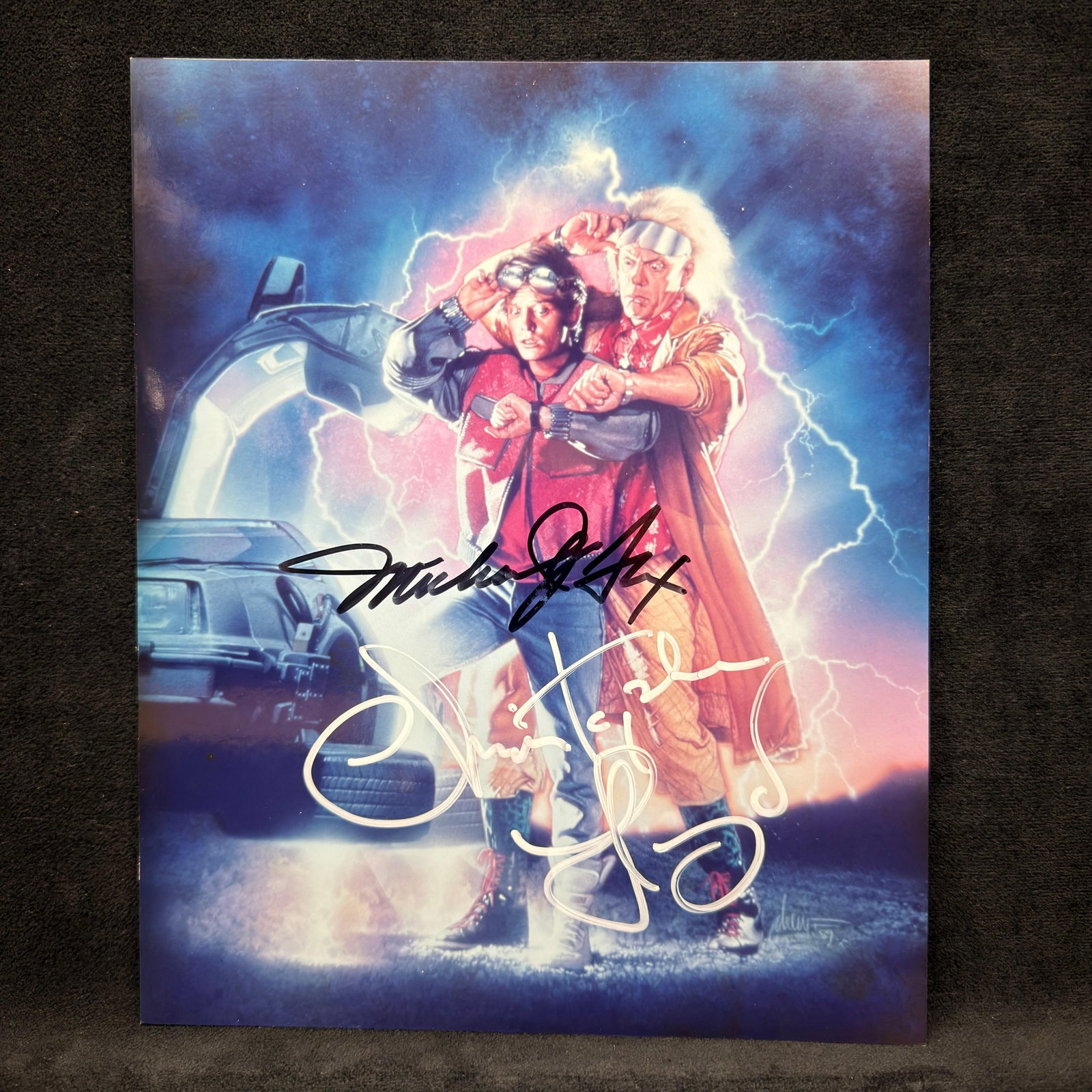 Back to the Future Photo Michael J. Fox and Christopher Lloyd Collectible R240: Color promotional photograph from Back to the Future featuring Marty McFly and Doc Brown, with signatures: Michael J. Fox in black marker and Christopher Lloyd in silver marker. Unframed and housed