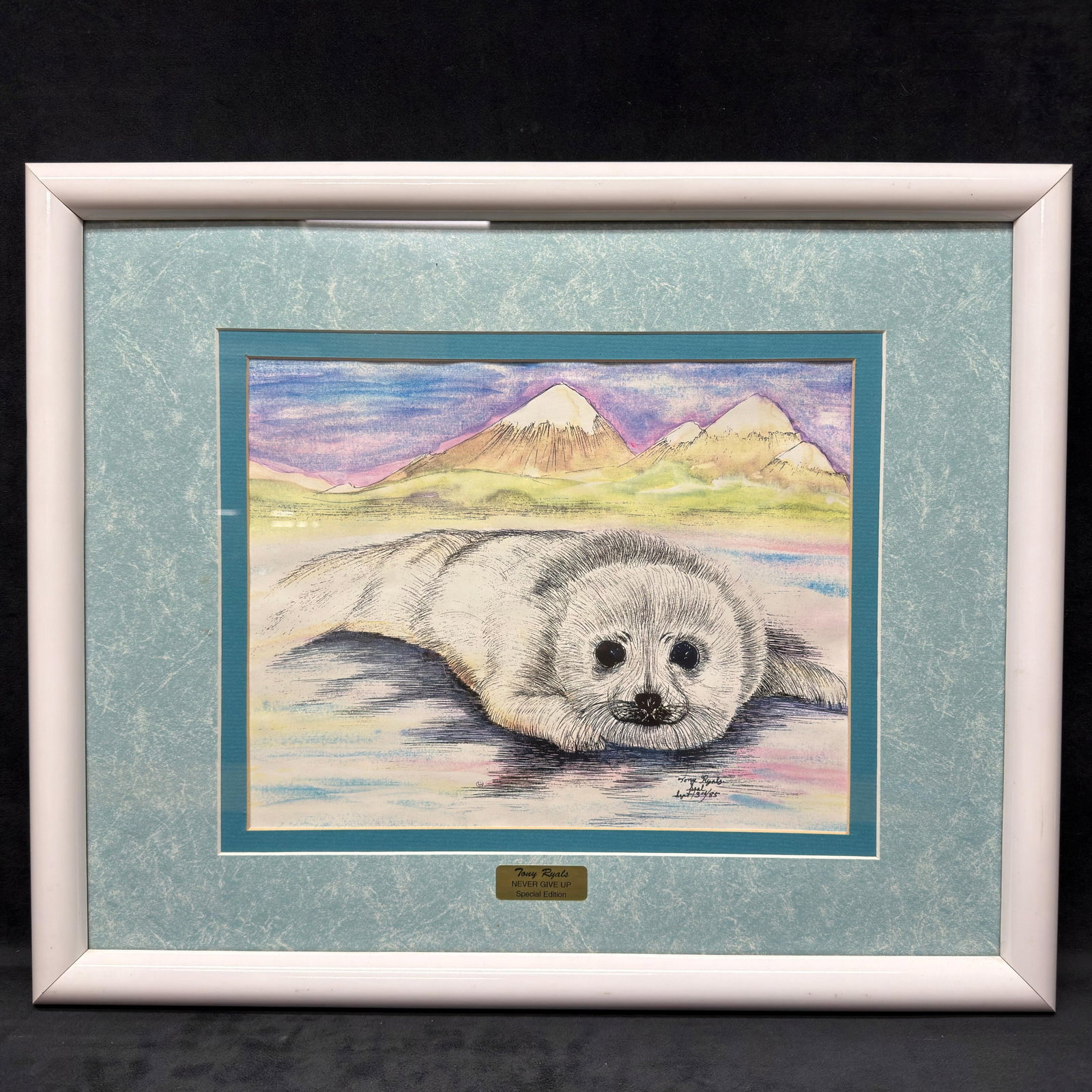 Tony Ryals Never Give Up Special Edition Signed Wildlife Art Framed R240: Framed special edition wildlife print titled Never Give Up by artist Tony Ryals, depicting a resting seal pup against an Arctic landscape. The work is hand-signed and dated September 3, 1985, in the