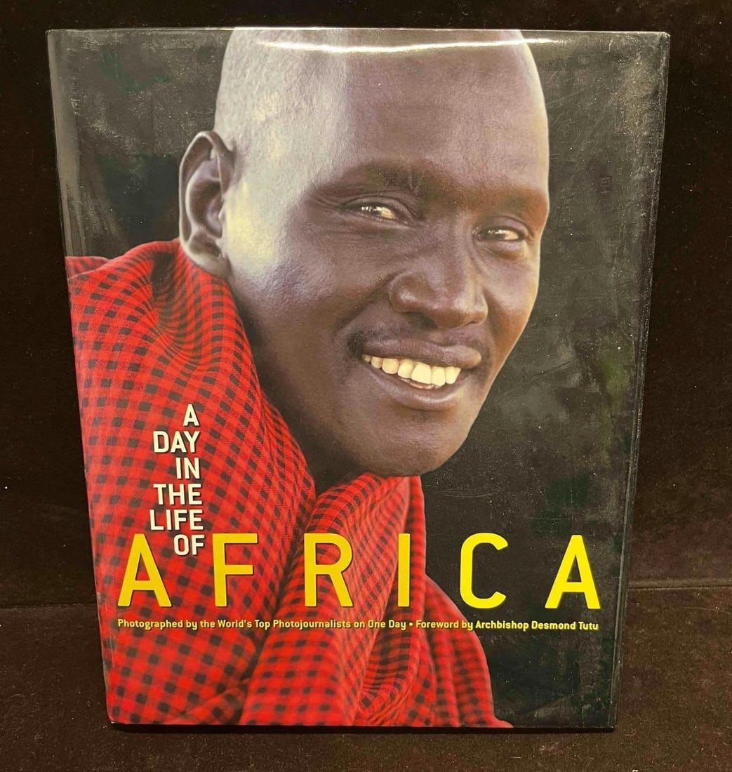 A Day In The Life Of Africa Tides Foundation: This lot contains a Hardcover copy of A Day In The Life Of Africa Tides Foundation. The approx. weight and dimensions are listed below. Overall the book is in good pre owned condition with minor wear 