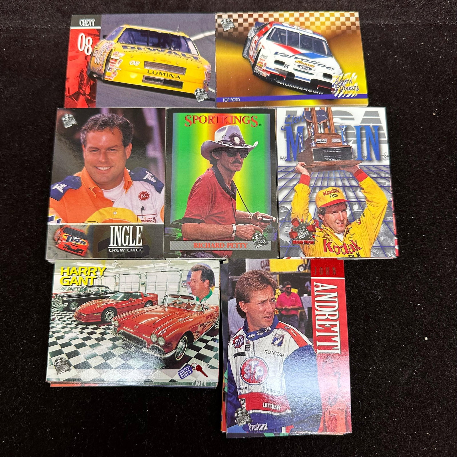 120 NASCAR Racing Trading Cards 1990s Richard Petty Sterling Marlin: Large group of 1990s NASCAR racing trading cards featuring drivers, crew chiefs, and race highlights from the NASCAR Winston Cup era. Cards appear primarily from Press Pass and similar racing card set