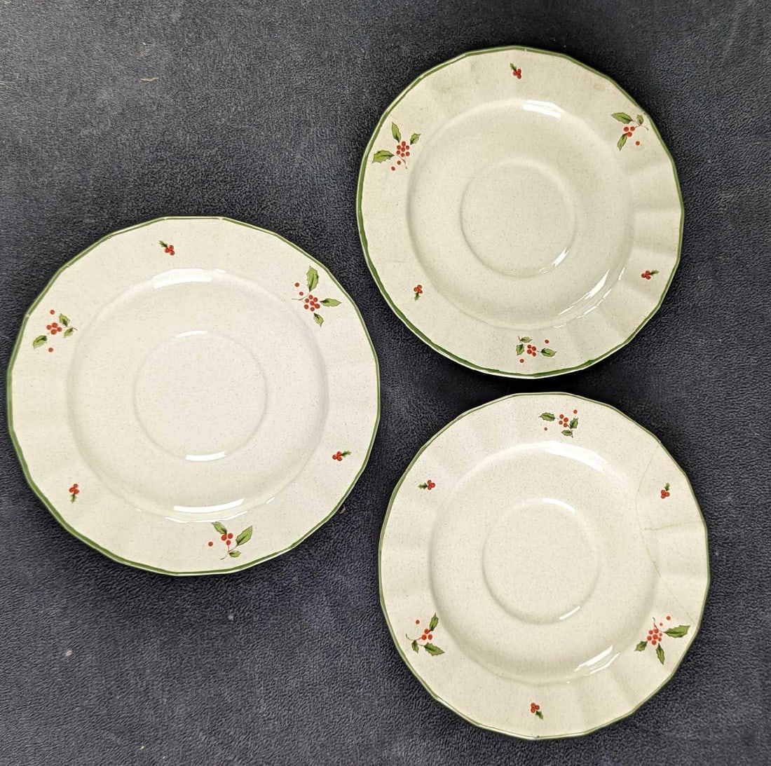 3 Retired Nova Studios Holiday Season Saucers: This series of fine china was released from only 1985 to 1987. The saucers are approx 6" and together they weigh 1.25lbs. The saucers are in a good, vintage condition with one saucer having a crack. P