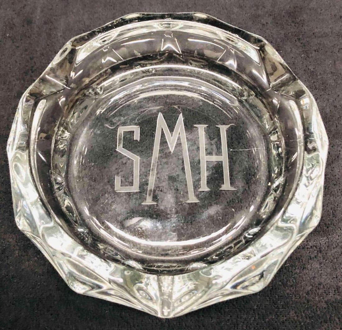 SMH Engraved Diamond Cut Glass Ashtray: This lot contains SMH Engraved Diamond Cut Glass Ashtray. It is approx. 6 1/4" x 6" x 1 1/2" and it weighs about 1.6lbs. Overall the Ashtray is in good used condition with some light wear from us