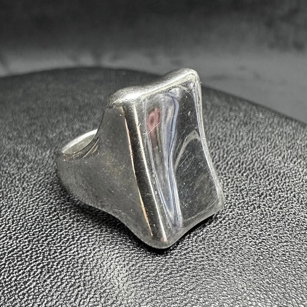 Sterling Rounded Rectangular Ring: This piece of jewelry has been tested and researched prior to listing. Please view all our pictures they are part of our description. DETAILS: Metal - Sterling Silver Color - Silver Stones - none