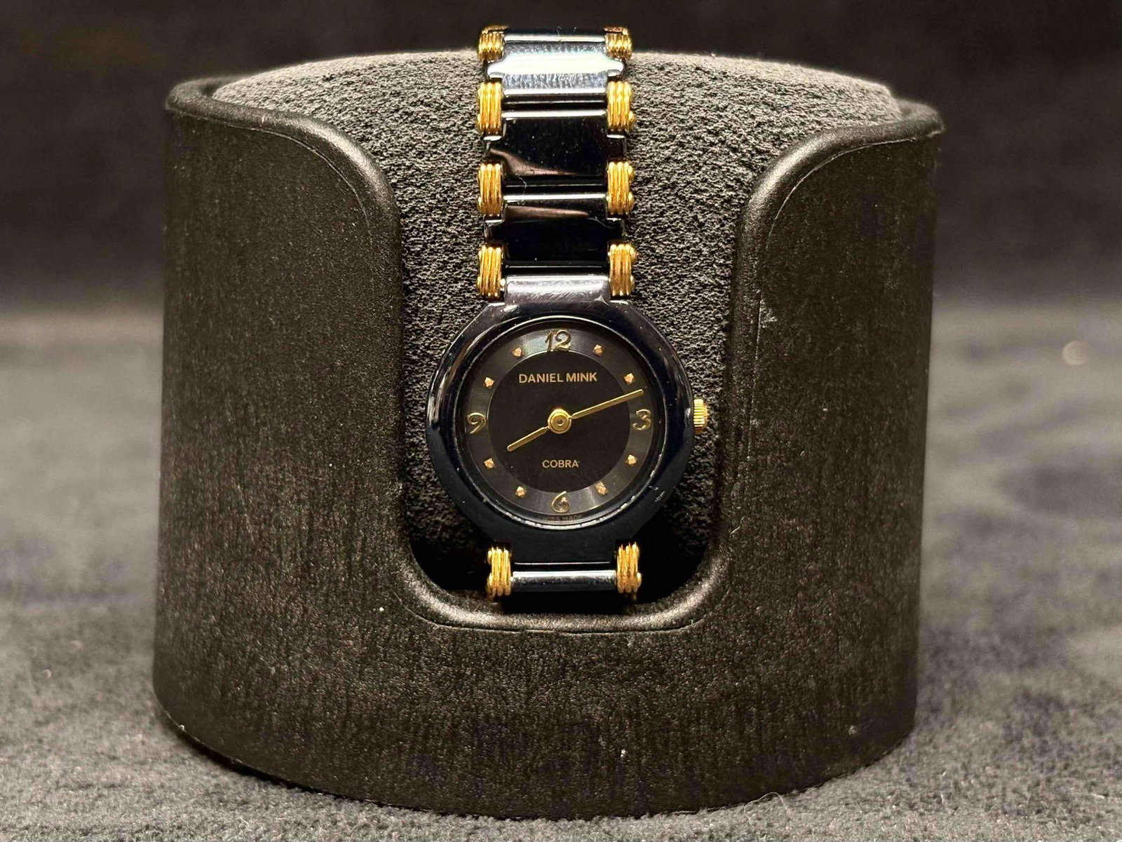 90s Vintage Daniel Mink Black and Gold Womens Watch and the Orbita Single Watch Holder Bundle: Purchased back in 1970s, this Daniel Mink Women's Watch has been kept tucked away in its matching velvet bag and box. This watch maintains its black and gold accent theme throughout, the Daniel Mi
