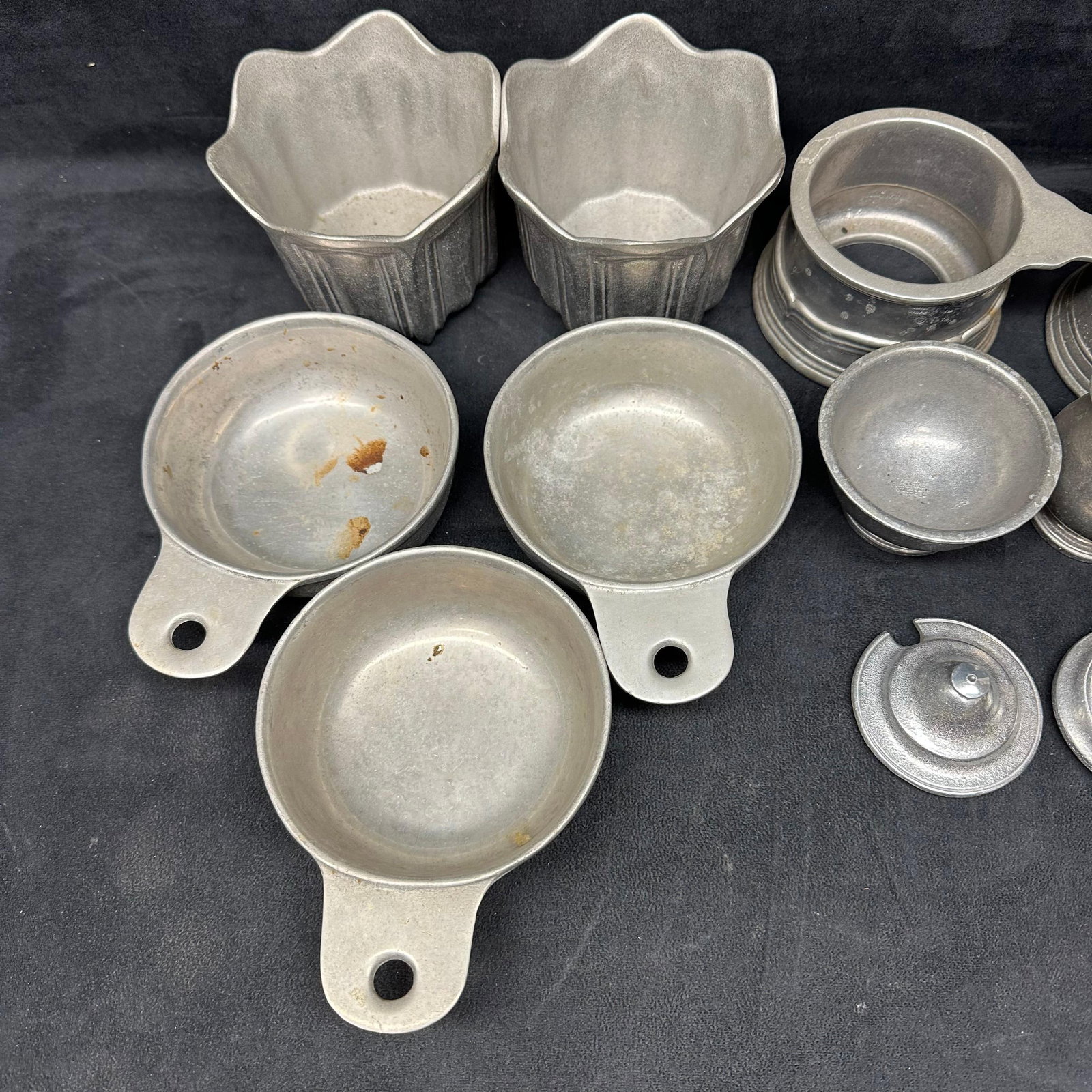 Lot of 12 Wilton Armetale Pewter Serveware and Cookware Pieces: Mixed lot of Wilton Armetale pewter serveware and cookware, all marked Made in USA. This collection includes a nice variety of forms and styles, from mini handled pans to molded ramekins, a pitcher, c
